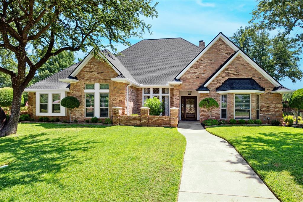 Beautifully updated custom 4-bedroom home, featuring Old Chicago Brick, new wood flooring, & located in the heart of Colleyville. Just minutes from major freeways, DFW Airport, Shopping & Entertainment, makes the location unbeatable! This spacious residence offers 2 full baths, 2 half baths, & multiple living areas—perfect for family living. Offering 2 inviting living spaces, one featuring a wood ceiling, a half bath & wet bar complete with a hammered copper sink, glass-front cabinets, & wine rack. This versatile space opens to the covered patio & pool, perfect for entertaining.  The primary suite offers high ceilings with a chandelier, a spacious sitting area, & a bay window with custom shades. The ensuite bath features beautiful custom cabinetry, jetted tub, separate shower, & large customized walk-in closet. Three additional bedrooms are split from the primary bedroom. One with high ceilings, a chandelier, & walk-in closet, & one with a walk-in closet & charming window seat. A recently updated full bath separates 2 bedrooms from the 4th which can serve as a dedicated office & includes hardwood flooring, high ceilings, ceiling fan, built-in shelving & desk. Enjoy dining in the elegant formal dining room with tray ceiling, crown molding, and chandelier. The breakfast nook features a custom octagon ceiling, chandelier, & lighted built-in China cabinet, overlooking the backyard. The updated kitchen includes wood floors, granite countertops, glass-front cabinets, under-cabinet lighting, microwave drawer, electric cooktop, double ovens with warming drawer, & pantry with pull-out shelving. A lighted utility closet is a bonus! Step outside to a private backyard retreat with a covered patio, in-ground pool with heated spa, cedar fencing, shed for storage & a meticulously landscaped yard. Easy access to Sparger Park with playground, pavilion & walking trails. Resident can apply during open enrollment to GCISD. This home won't last long, so call & request a showing today!