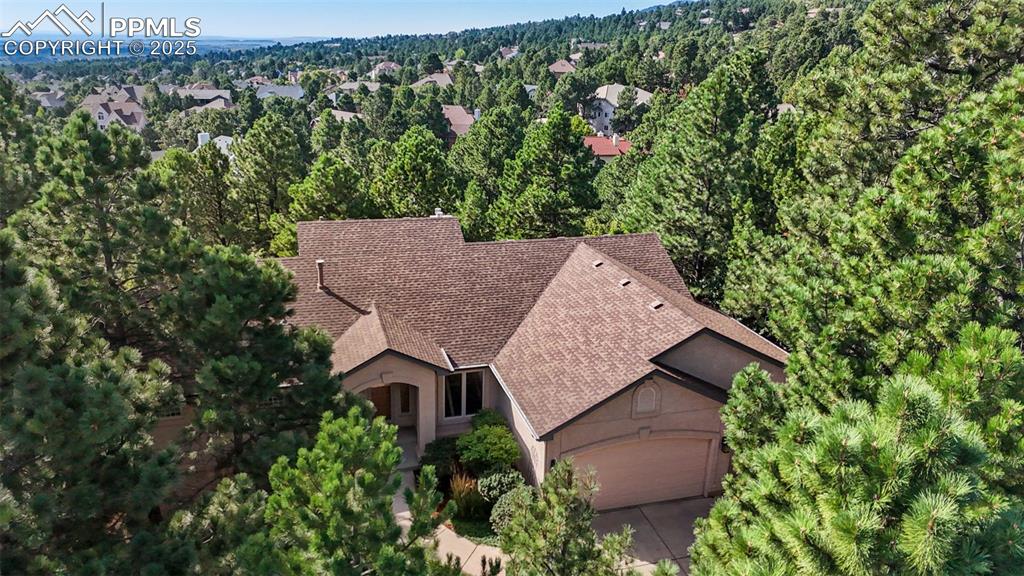 Hidden among soaring pines, this custom ranch retreat delivers massive privacy and a true escape from the ordinary —Welcome home, where refined luxury meets the calming serenity of nature * Thoughtfully designed interior blends soaring ceilings with expansive open spaces, perfectly complementing its tucked-away, private flag lot setting * Mature trees & tranquil outdoor living areas surround the residence, creating a setting that feels both secluded and inviting* From the moment you enter, floor-to-ceiling windows and high ceilings captivate you, blurring the lines between indoors & outdoors * The great room impresses with its scale and a dramatic three-sided fireplace, offering warmth and ambiance for both intimate evenings and lively entertaining * The chef’s gourmet kitchen is a showpiece with granite slab Island, rich and modern maple cabinetry, all stainless appliances to include 5-burner Thermador cooktop, a brand-new double oven and walk-out access to an expanded Trex deck (just under 3 years old) w/natural gas stub & New Powered Awning * Private outdoor sanctuary is perfect for gatherings or quiet reflection among the towering pines * Main level living is effortless, enhanced by wood floors, updated lighting and a serene primary suite featuring a spa-worthy 5-piece bath and oversized walk-in closet with built-ins * Well-planned mudroom with laundry sits ideally off the garage entrance & completes the main level * The walk-out lower level extends functionality with a spacious family room, full wet bar, floor-to-ceiling windows and a second fireplace * Huge concrete patio is a great secondary outdoor retreat * Three oversized bedrooms offer comfort & flexibility, including two joined by a thoughtfully placed Jack-and-Jill bath * New central air, newer roof, and fresh interior paint ensure peace of mind while showcasing elegance and functionality throughout * Truly, hard to find location delivering an easy lifestyle only minutes from city conveniences * HURRY!