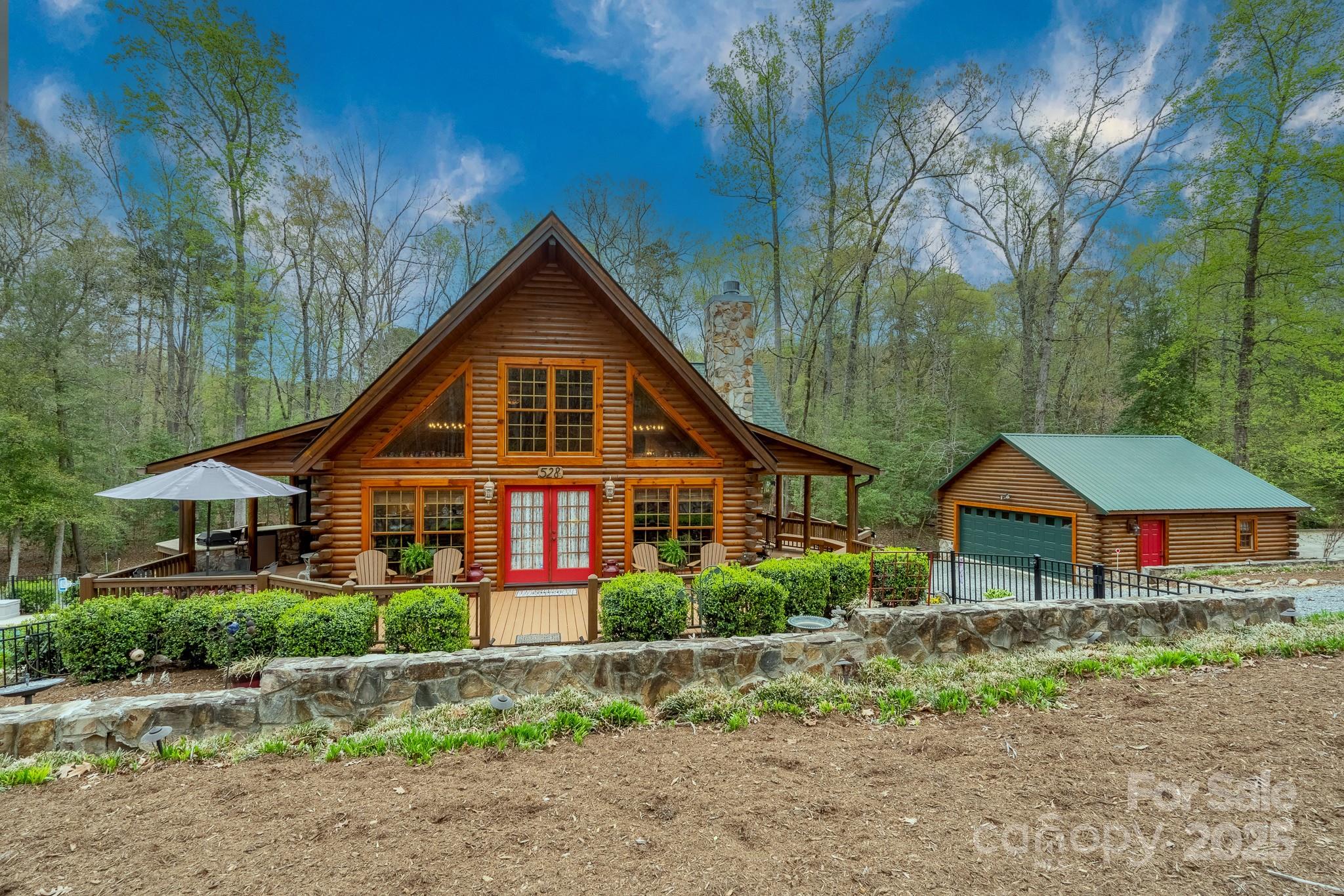 Welcome to your luxury log cabin retreat at the lake on 1.38 acres! Short Term Rental Opportunity or Private Getaway! Fiber Internet! Nestled in gated lakeside community, Woodrun, just minutes from Lake Tillery. Featuring gorgeous in-ground pool, outdoor shower, hot tub, fireplaces, fire pit, outdoor kitchen, & wraparound porch. Enjoy the ambiance of the meandering creek bed. Step in to grand 2-story great room w/ cathedral ceiling & open floor plan for hosting, heart-of-pine wood floors, cozy gas fireplace, & custom cabinetry. Private primary suite on upper level w/ en-suite bathroom & loft area. Two bedrooms on main level & flex room in basement. Plenty of parking in detached 2-car garage & driveway - room for boat/RV. Woodrun Amenities: lakefront pool & clubhouse, boat ramp access to Lake Tillery, playground, walking trails, tennis/pickleball & basketball courts, boat slips & dry storage for lease (waitlists apply). Located under 3 miles from entrance of Uwharrie National Forest.