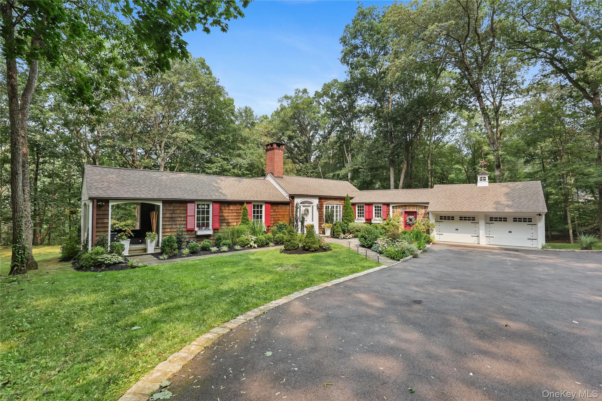 Hywood Ledge is a spectacular expanded ranch in the desirable Deepwood neighborhood of Chappaqua, which presents sophisticated charm and tranquility. This cedar-shake beauty is perfectly situated at the end of a cul-de-sac on 1.9 acres, offering unparalleled privacy, yet only 5 minutes to the center of town and the Chappaqua Metro-North. The home was renovated between 2000-22 offering years of peace of mind with quality upgrades: new roof (2020); new boiler (2020); new above-ground oil tank (2020); new 1250 gallon septic tank (2020); new Marvin Elevate, divided light windows (2021); professional landscaping (2021); electrical updates that include a 220V garage car charger and a house generator interlock with electrical sub-panel (2021); Belgium block driveway (2022). A gorgeous great room with James Allan lighting anchors the house with a wood burning fireplace, across from the beautifully renovated eat-in kitchen with custom maple Omega cabinetry. A chef’s dream is complete with large Viatera Quartz countertops plus state-of-the-art Wi-Fi supported Samsung induction cooktop and Family Hub refrigerator. Stunning floor to ceiling wrought-iron doors lead to a new multi-level Trex deck perfect for outdoor entertainment. The home’s wonderfully curated renovations carry through to the first-floor primary bedroom, with an ensuite bath with Italian mosaic tile work surrounding the spa like walk-in shower accompanied by a gorgeous copper soaking tub. The lower-level features two beautiful bedrooms with their own personal full bathroom. The bonus recreation room offers numerous possibilities for additional living and workspace. The moment you drive through the stone entry pillars, you will want to call Hywood Ledge your own.