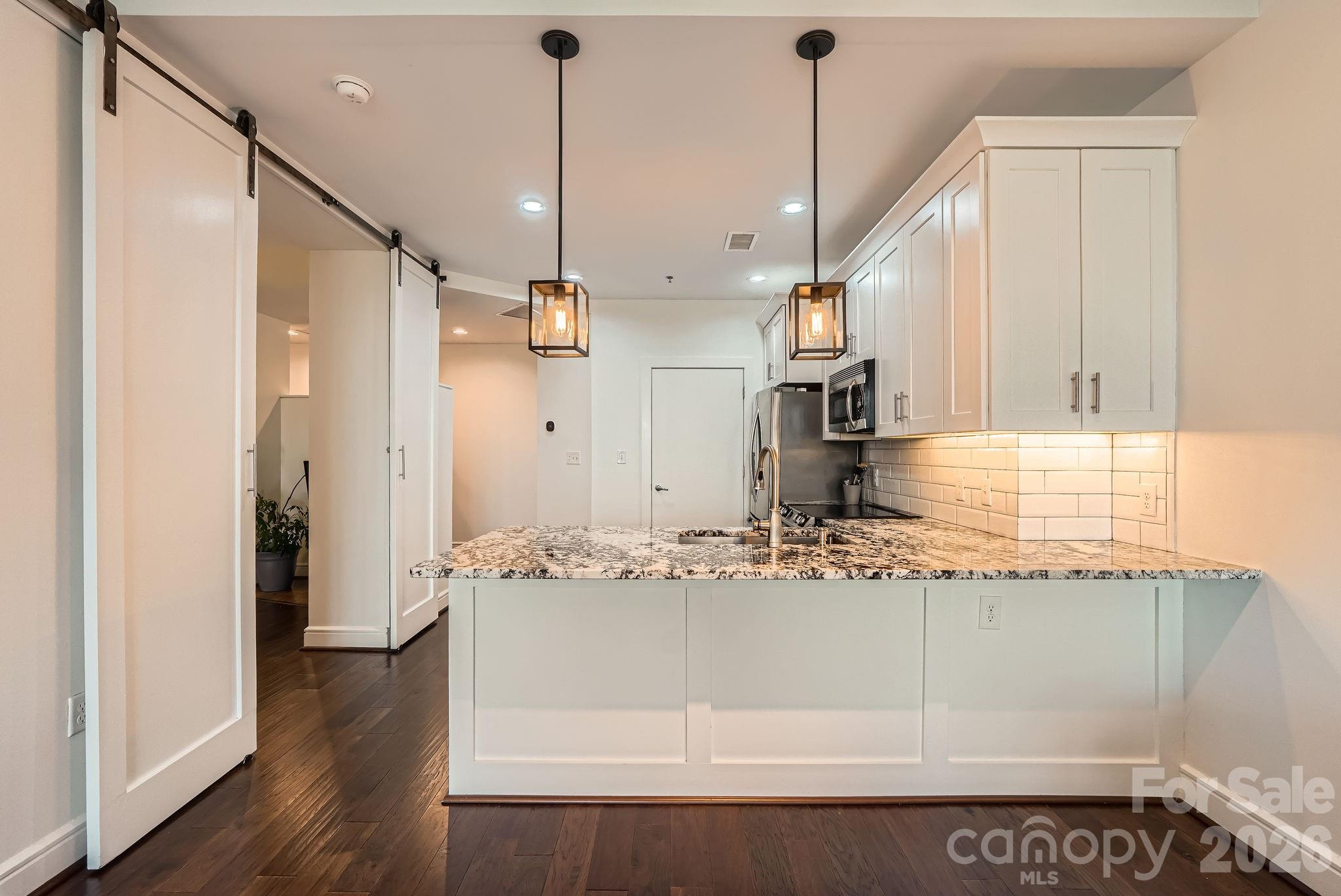 Experience elevated Uptown living in this beautifully renovated 1 bedroom Plus DEN -condo at 333 West Trade, Unit 2002! Offering breathtaking skyline views and modern luxury, this move-in-ready residence has been extensively updated with high-end finishes throughout. Recent renovations include new flooring installed last year, upgraded cabinetry, stylish countertops, and a fully refreshed kitchen featuring all new appliances. Major system upgrades include a brand-new HVAC system and new washer & dryer, providing comfort, efficiency, and peace of mind.This light-filled open-concept floor plan offers spacious Kitchen and Living areas, ideal for entertaining or enjoying vibrant Uptown Charlotte living. Step onto your private balcony and take in stunning city views from the 20th floor. Located in one of Uptown Charlotte’s premier high-rise communities, residents enjoy convenient access to restaurants, nightlife, Panthers games, entertainment, shopping, and the light rail. Building amenities include:Sky terrace Pool, Gas Grills, Clubhouse, Gym, Fire Pit, EV charging stations, Amazon Hub.Whether you are searching for a luxury Uptown Charlotte condo, a fully renovated high-rise residence, or an exceptional investment opportunity, this condo delivers style, location, and value. Don’t miss your chance to own a beautifully updated condo in the heart of Charlotte!