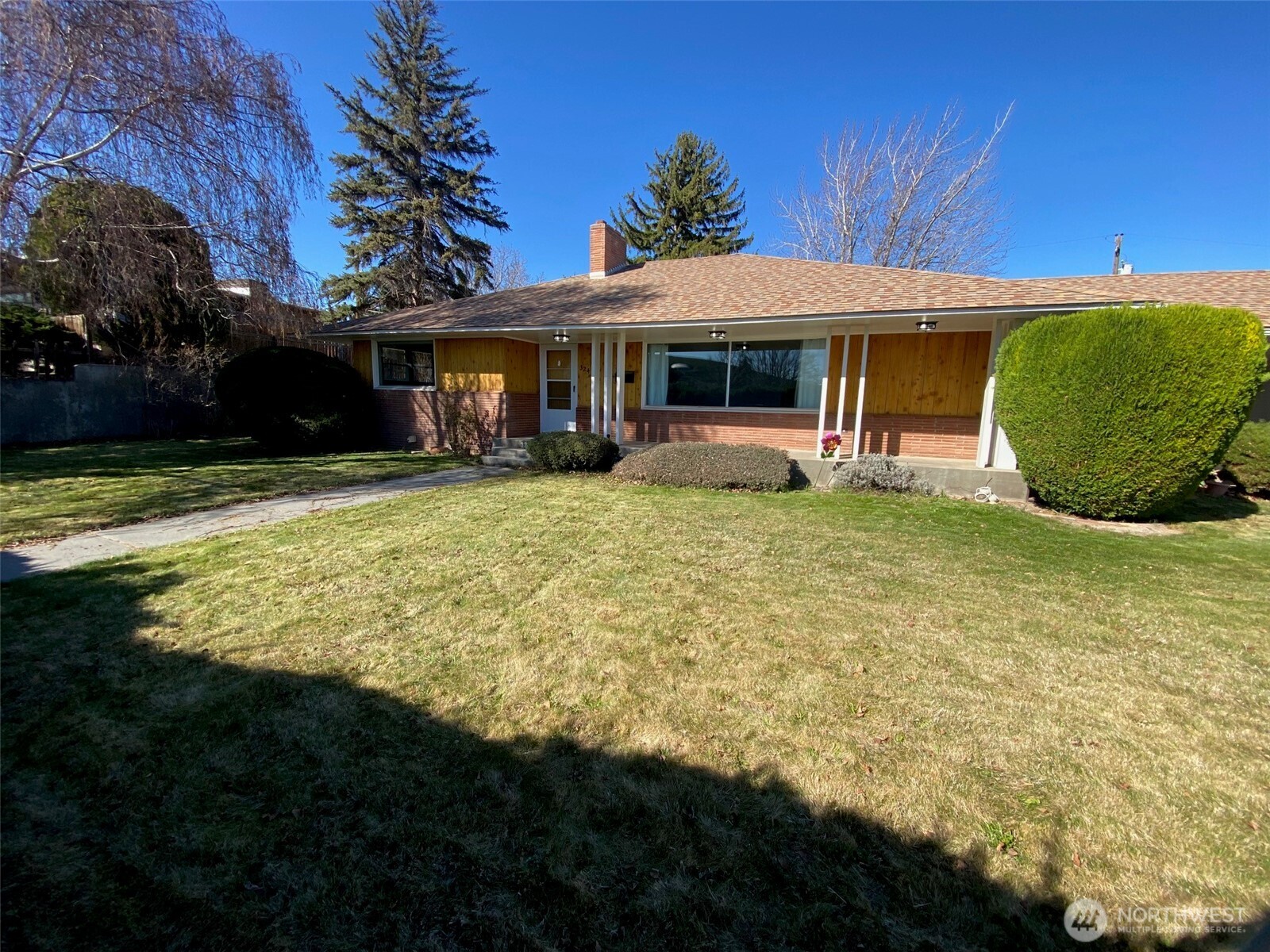 Spacious brick and cedar plank 5 bedroom home on double lot with detached garage, fenced backyard, underground sprinklers and hedge in front that affords a very private feel.  The main floor has 3 bedrooms, full bath and half bath off kitchen.  Large living room with wood burning fireplace.  Dining room with patio door to back yard. Kitchen features solid surface counters with room to spread out. Breakfast nook for informal dining.  2 bedrooms in basement have conforming, egress windows.  3/4 bath downstairs.  Large Rec Room downstairs with bar and additional wood burning fireplace. Detached garage with large driveway.  This is a great home with lots of room for everyone