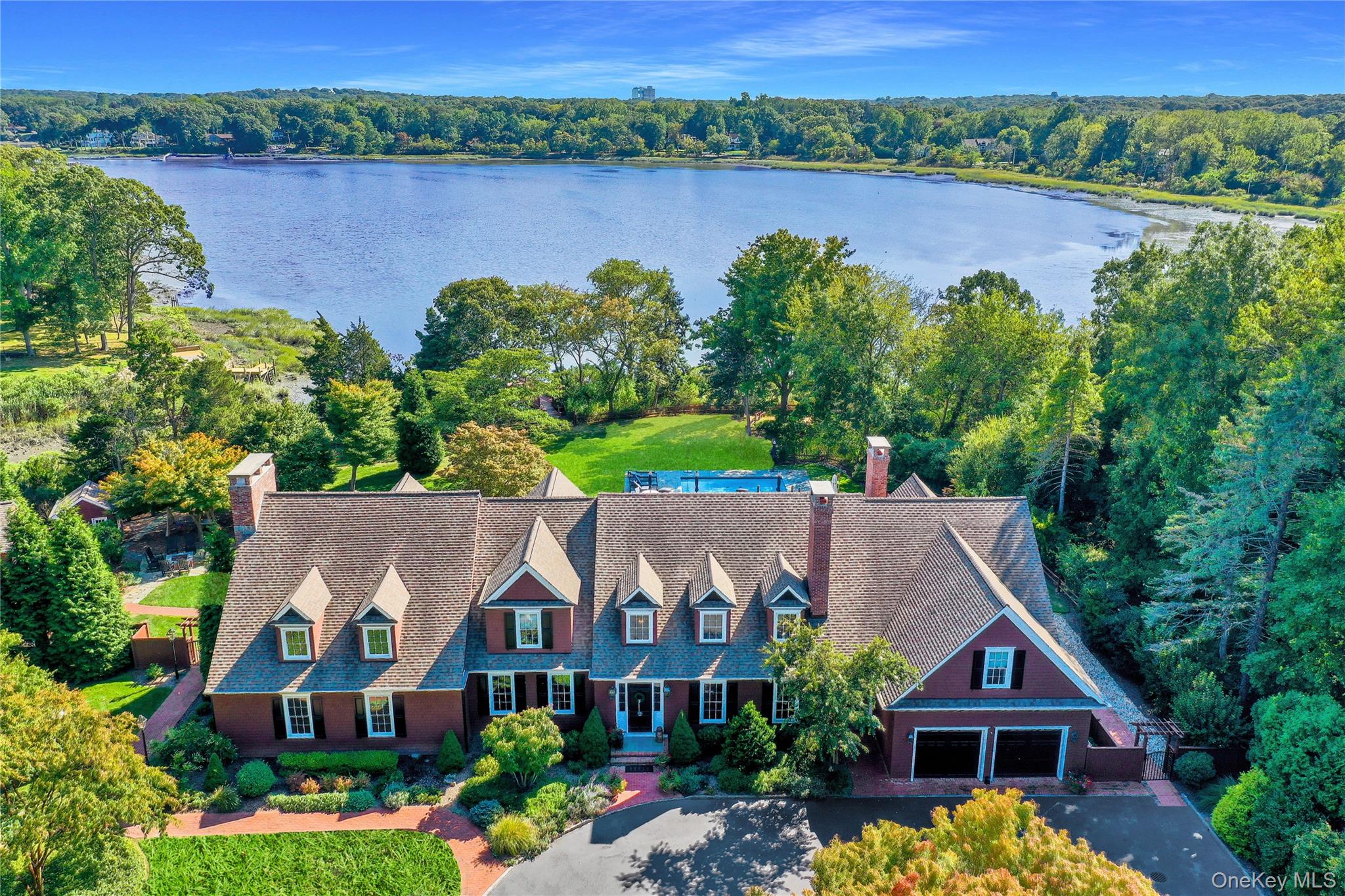 Magnificent Country Waterfront Estate on shy 3 acres tucked away in Strong's Neck, Setauket..1000' on Little Bay w. private dock , Privacy with rustic elegance and designed for large family with top of the line furnishings. 5 Bedrooms 6.5 baths with grand entertainment room w. large stone Frpl and soaring ceilings, beautiful custom lighting and a full bar area, The Kitchen is outfitted with Stainless appliances and large island, radiantly heated Brazilian cherry wood floors. Outdoors this Estate is designed for entertaining with an expansive decking and patios with built in BBQ station and fireplace, Pergola and In-ground pool, 4 garages 2 attached 2 detached, 6 fireplaces, private manicured level acreage with great privacy for family compound. A Rare Opportunity to combine Elegance, recreation and a Serene waterfront lifestyle.