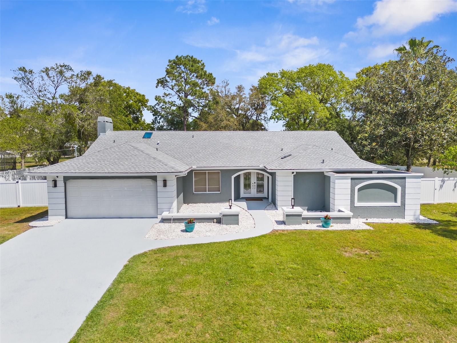Discover a home that truly has it all—perfect for multi-generational living, rental income, or simply spreading out in style. This beautifully remodeled estate offers a private in-law apartment with its own entrance, full kitchen, living room, and ensuite bedroom—ideal for guests, family, or extra income.

The main residence features 3 bedrooms, 2.5 baths, and designer touches throughout—quartz countertops, custom cabinetry, sleek tile floors, and a cozy fireplace. Step outside to your heated saltwater pool under nearly 2,000 sq. ft. of screened enclosure, creating the ultimate Florida retreat for entertaining or relaxing in privacy.

With a ½-acre fully fenced lot, 2-car garage, smart-home upgrades, and no HOA restrictions, this property delivers flexibility, comfort, and freedom—everything today’s buyers are searching for.