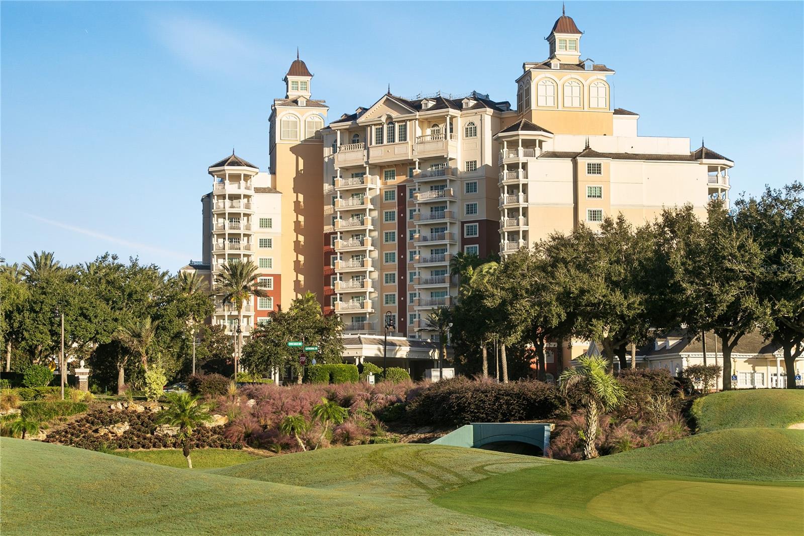 LOCATION LOCATION LOCATION. Active resort membership available. Own 1 out of a total of 6 one bedrooms in the entire building. This unique and adorable 1 bedroom condo is located in the Reunion Resort Grande Located next to the Clubhouse where the Watson and Palmer courses meet, enjoy 180 degree views from your corner balcony.  Every window offers a spectacular golf course view that always excites.  Take a complimentary shuttle to the third golf course, the Nicklaus, to enjoy dinner at Traditions.  Finish the evening back home at the Grande with desserts at the rooftop restaurant, Eleven, while you sit by the pool and enjoy the nightly Disney fireworks.  In the mood for sushi or fine dining?  The lobby bar,  sushi restaurant, and the Chophouse welcome you to some of the finest dining in Orlando.  In the morning, pop down to the lobby for a Cappuccino from Starbucks. True luxury living for a full time residence or part time enjoyment!  This suite is a sought-after rental in the Reunion rental program should you choose to make this a part time residence.  Just store your beach towels in the owner’s closet and lock and leave! This condo was freshly painted and professionally decorated. The Resort offers incredible amenities from 3 World Class Championship GOLF COURSES designed by Arnold Palmer, Tom Watson And Jack Nicklaus as well as 12 pools in community including MULTIMILLION DOLLAR WATER PARK with lazy river & water slide. **Property comes with an Active Reunion Resort Membership** Any property without a Resort membership may not be able to use any of the amenities.