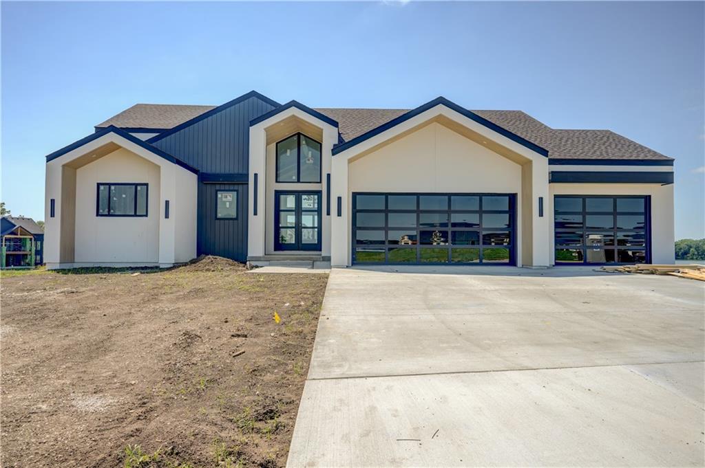 Completely custom lakefront home with amazing views on the private Lake Winnebago! Walker Custom Homes has been combing through every detail of this one of a kind elevation to make this the perfect lakefront living experience. This custom home is located on an estate-sized lakefront lot within the esteemed Lee's Summit School District! 

The floor plan features two bedrooms on the main level, and two bedrooms in the basement, ALL with AMAZING main channel lake views and their own full bath. Main level includes open concept living/kitchen/dining perfect for entertaining. The vaulted ceilings that carry through from the porch, to the living room, and even onto the deck, are breathtaking. Don't miss the large prep kitchen and stainless appliances. Basement includes media room, lake-day bathroom, full wet bar, and HUGE workout room or flex space. Oversized suspended garage with extended third bay. Bonus garage door off back of house is perfect for all the lake toys! Large deck includes sun deck off master bedroom, fireplace with hookup for TV, and composite decking. Too many upgrades to list, so schedule a time to meet with this amazing builder to talk through all he has planned! 

You cannot beat this lot location; it has it all...calm cove waters for your dock with full main channel views. This lot is also located on a private large circle drive, with over an acre of greenspace across the street! This is a must-see custom lakefront home. Estimated finish date is Summer of 2025. One of the only new homes that will be ready for this SUMMER!