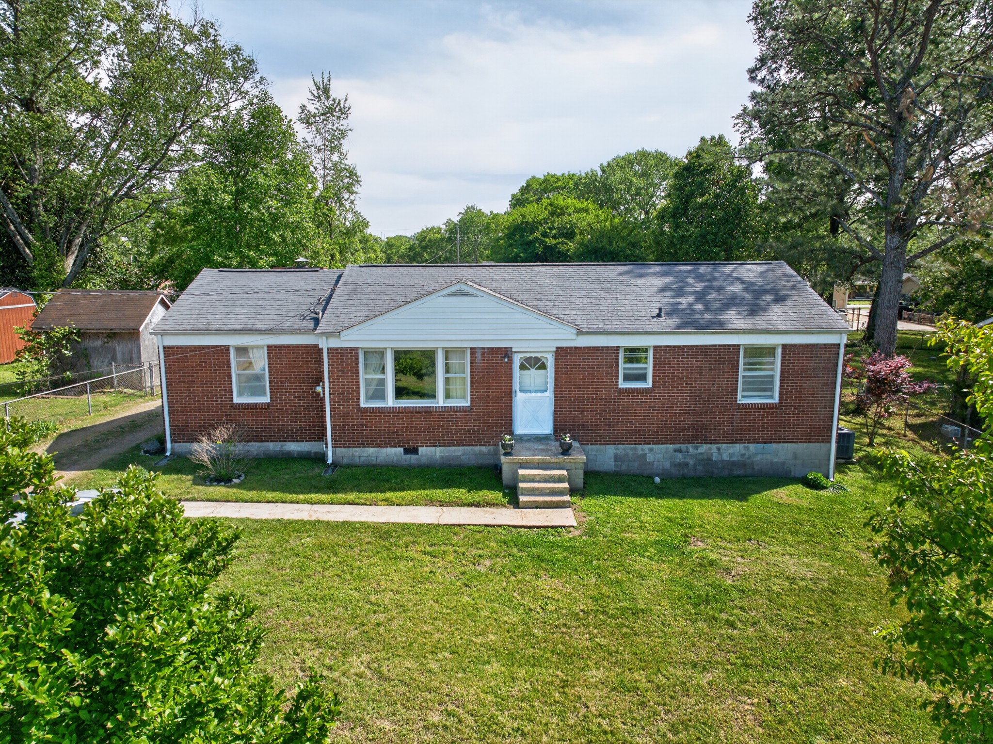 Opportunity is knocking in Hill Estates. If you’ve been hunting for a Franklin property with solid bones, a flat lot, and real upside, this one deserves a look. This 1965 ranch sits on just under 1/3 acre and offers a layout buyers and investors love: a front living room, three bedrooms and a renovated full bath down the hall, an eat-in kitchen with room for a table and a window over the sink overlooking the backyard, plus a den addition off the kitchen that adds valuable flex space with the laundry tucked neatly behind closed doors. Outside, the covered patio and fenced backyard create room to relax, garden, entertain, or plan your next improvement project under a canopy of mature trees. Big-ticket items already addressed include the roof, replaced around 2015, and the water heater, replaced about three years ago.Located in established Hill Estates, this is the kind of property that keeps drawing attention thanks to its vintage character, no-HOA setting, and convenient access to Downtown Franklin, The Factory at Franklin, The Park at Harlinsdale Farm, Pinkerton Park, Columbia Ave, and Mack Hatcher Pkwy. Offered as-is, this home presents a great chance for buyers who want to get into Franklin, add value over time, or secure a smart investment in a location where opportunity is getting harder to find. Whether you’re a first-time buyer ready to build equity, an investor looking for your next rental, or a renovator searching for your next project, this one is full of potential.