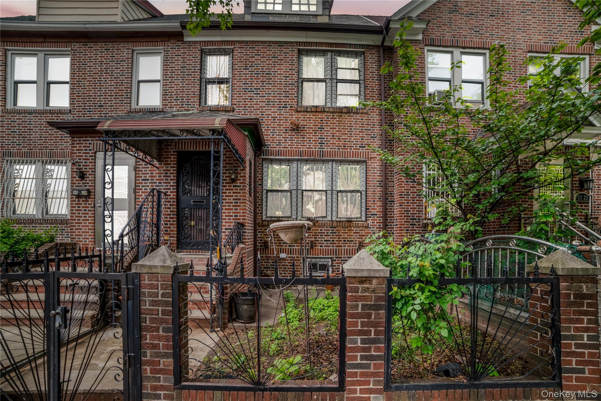 This sun-drenched, attached brick home in the heart of Jackson Heights offers the ultimate in urban convenience, situated just moments from the E, F, M, R, and 7 subway lines for a seamless 20-minute commute to Manhattan or LaGuardia Airport. You are welcomed by a proper entry foyer that leads into an expansive first floor, featuring gleaming hardwood floors throughout, a sprawling living room, a formal dining area, and a functional kitchen with an abundance of closet space. The second level boasts three bright bedrooms and a full bath, while the private backyard provides a perfect outdoor retreat alongside the rare convenience of a private garage and an additional parking spot. Complete with a full finished basement featuring a separate entrance, a bathroom, and laundry facilities, this home offers natural gas heating and remarkably low taxes of just $8,049, making it a turnkey opportunity located steps from world-class dining, major shopping, and local parks.