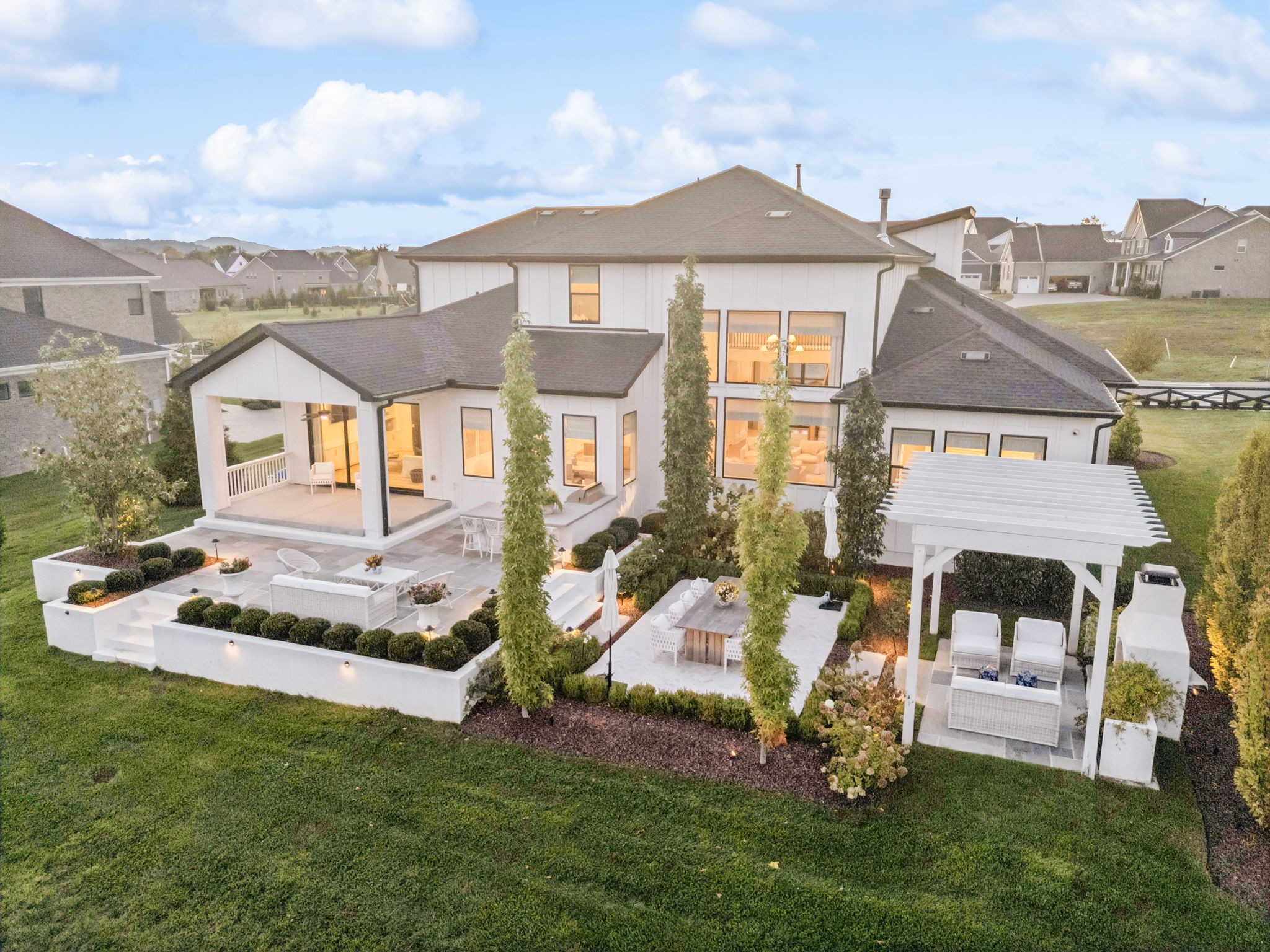 Looking for a luxury home that feels calm, polished, and intentional—without leaving Nolensville? This five-bedroom, five-and-a-half-bath modern estate sits on a rare 0.62-acre lot in the Annecy community, offering space, privacy, and refined design just minutes from daily conveniences. Natural light pours through floor-to-ceiling windows, setting a peaceful tone from morning to night. The open layout flows effortlessly, anchored by a custom chef’s kitchen with high-end appliances, statement lighting, and more than $475,000 in designer upgrades throughout. Every finish feels considered, elevated, and timeless. Outdoor living is a true highlight. A covered patio and built-in cooking area create the perfect setting for sunset dinners and relaxed entertaining with views and privacy. Inside, five spacious bedroom suites, flexible bonus rooms, and a three-car garage support both family life and hosting. Annecy residents enjoy a pool, clubhouse, playground, top Nolensville schools, and easy access to I-65 and Wilson Pike.