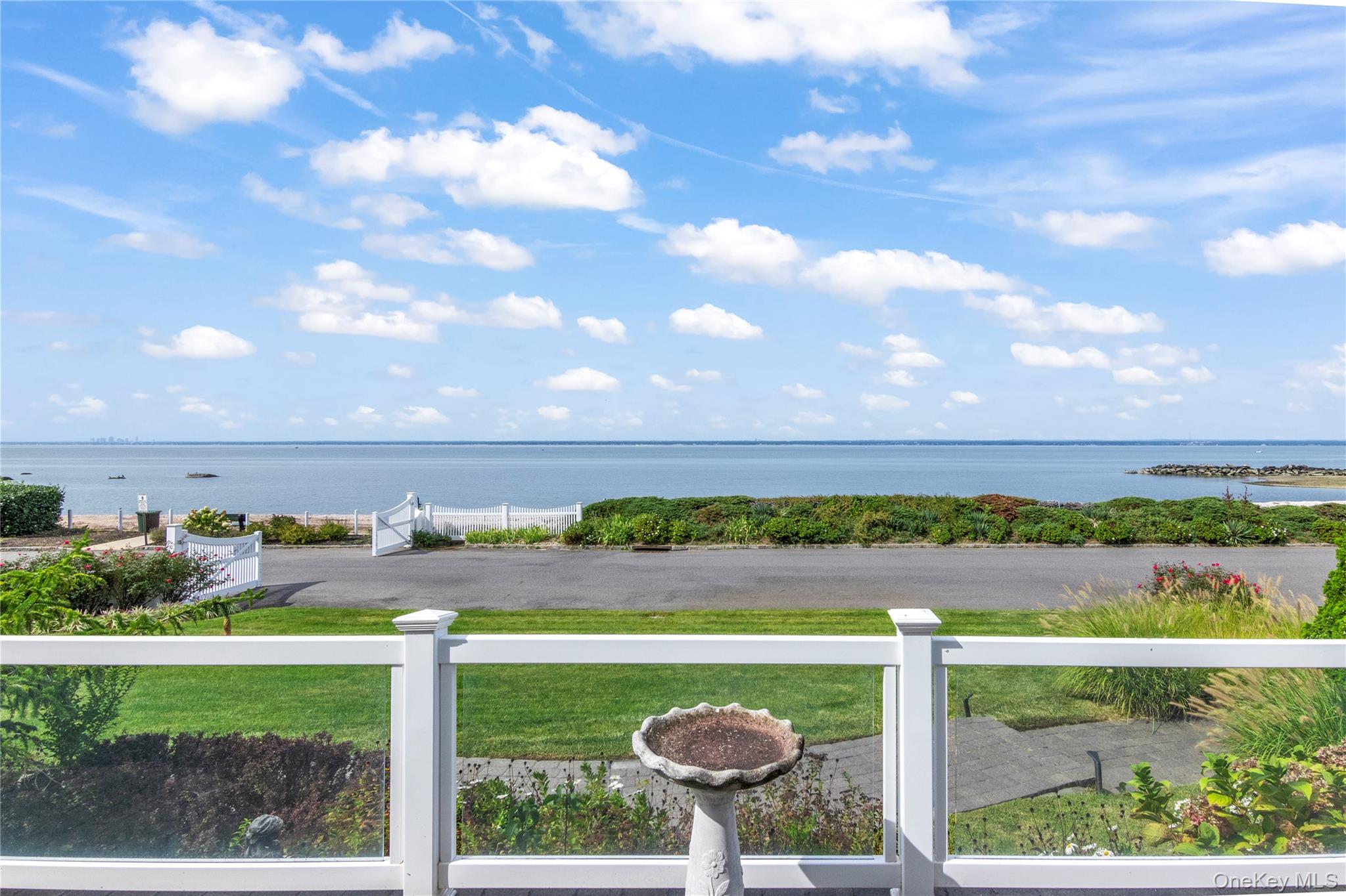 Location Location Location on desirable Mohring Bay Court! 180-degree unobstructed views of Long Island Sound, yet NOT IN A FLOOD ZONE! This beautiful home offers approximately 2500 sq-ft of modern living with high ceilings, 3 bedrooms, 3 baths, natural gas heat, CAC, CVAC, 2nd-floor laundry, finished basement, 2-car heated garage with Tek System, and gas whole house generator. Situated on over 1/3 acre, this residence boasts a sparkling vinyl inground heated salt-water pool, separate hot tub, large front porch, huge rear deck and patio, outdoor granite kitchen with natural gas grill, plus a large shed. Enjoy panoramic water views from every window, and relax in the Primary Suite featuring an en-suite bath and a coveted private balcony overlooking the Sound. Locust Valley schools, taxes under $18k.