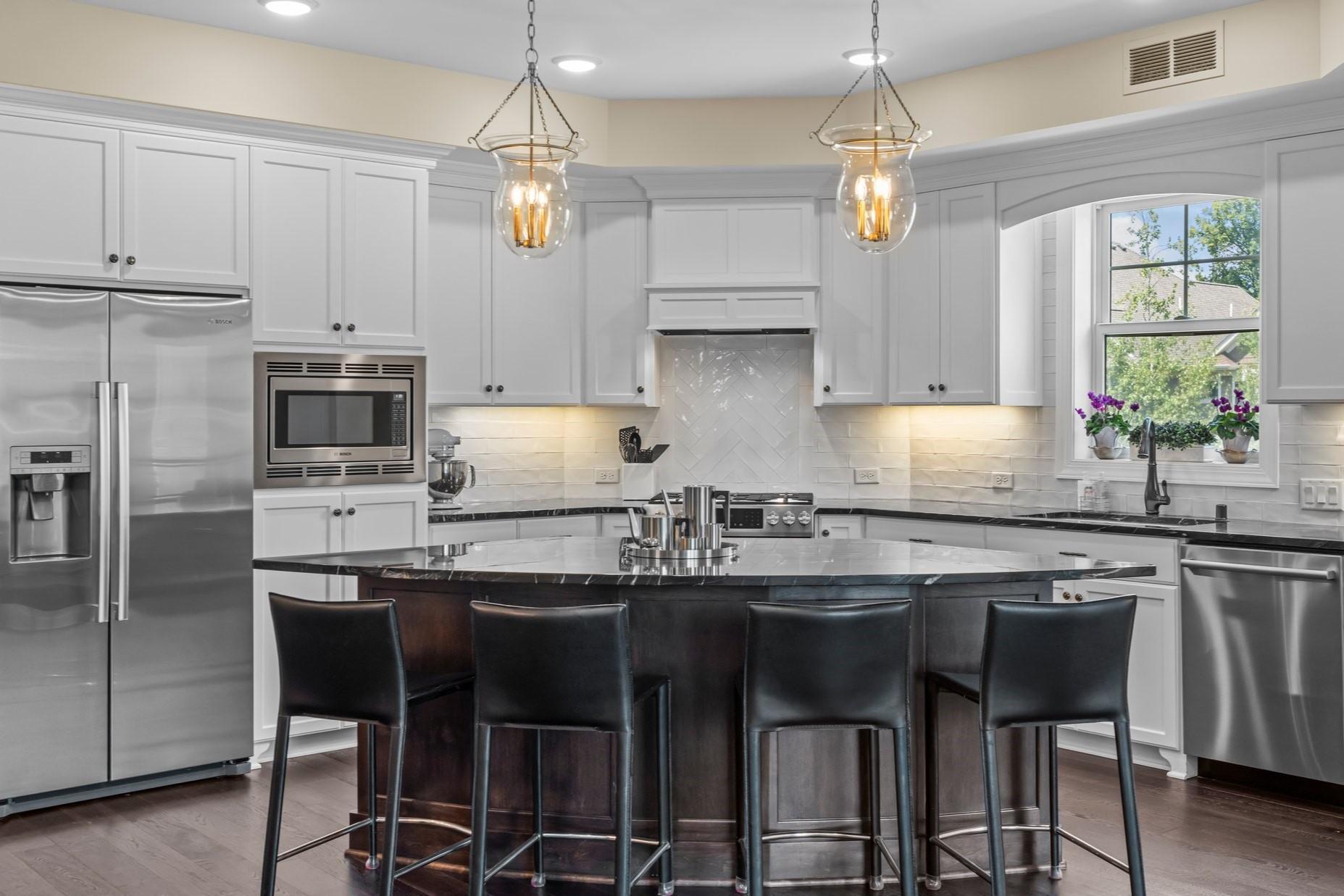 Welcome to this beautiful and spacious 2-bedroom, 2-bathroom condo—perfectly located just minutes from vibrant downtown Wayzata. Enjoy effortless access to Ridgedale Center, scenic lakes and trails, top-rated restaurants, and shopping. Nestled near Gleason Lake, Parkers Lake, and Wayzata Central Middle School, this home offers the ideal blend of lifestyle, comfort, and location.
Inside, the open-concept layout is both stylish and functional, designed for seamless everyday living and entertaining. The standout kitchen boasts sleek Bosch stainless steel appliances, a tile backsplash, abundant cabinetry, and an oversized center island with breakfast bar seating—perfect for cooking or gathering. Just beyond, the designated dining area features wood flooring and a striking light fixture, creating a welcoming setting for everything from casual dinners to celebrations.
The bright and airy living room is bathed in natural light from oversized windows and enhanced by the peaceful, unobstructed views exclusive to this corner unit. A stunning gas fireplace with a floor-to-ceiling stone surround and elegant mantle anchors the space, while built-in cabinetry adds both style and storage. An updated ceiling fan completes the room with comfort and functionality.
The generously sized primary suite features a tray ceiling with ceiling fan, soft carpeting, and an expansive 10x7 walk-in closet with built-ins for easy organization. The private en suite bathroom is perfect for relaxing with tile flooring, a spacious walk-in tiled shower, and a double vanity with ample counter and cabinet space.
The second bedroom is equally comfortable, with plush carpeting, a ceiling fan, and a large closet. A shared full bathroom offers a combined tub and shower with an updated glass door (2019), beautiful tile surround, tile flooring, and a linen cabinet. A nearby hall closet adds even more convenient storage.
This thoughtfully designed unit also features a finished in-unit laundry room with a stacked Frigidaire washer and dryer, cabinetry, a sink, and a wine cooler (2019). Two additional closets near the entryway ensure there’s a place for everything. For added convenience, the unit includes two assigned underground parking spaces (tandem), keeping your vehicles protected and easily accessible year-round.
Step outside to relax on the maintenance-free 11x8 deck—ideal for enjoying your morning coffee or unwinding at sunset. Residents also enjoy access to premium community amenities, including a fitness center, guest suite, and a stylish club room with a full kitchen—perfect for hosting gatherings.