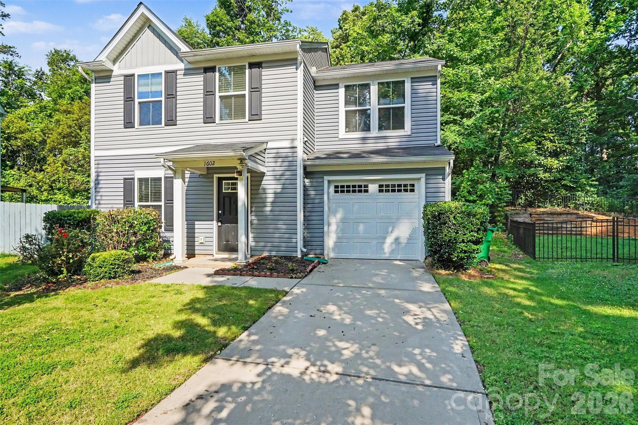 Welcome to this move-in-ready 3-bedroom, 1.5-bath single-family home nestled on a private cul-de-sac lot. Freshly painted throughout, the open-concept floor plan is filled with natural light and features a spacious kitchen with an island, tile backsplash, and stainless steel appliances. Gleaming wood flooring flows throughout the main level, while brand-new carpet adds comfort upstairs, where you’ll find three generously sized bedrooms and a full bathroom with dual vanities. For added convenience, the washer, dryer, and refrigerator are all included. Step outside to enjoy the fully fenced backyard featuring an extended patio—perfect for relaxing, entertaining, or outdoor living. Ideally located with easy access to Independence Blvd, I-277, I-77, and I-85, this home offers a convenient commute to Uptown Charlotte and Charlotte Douglas International Airport. Don’t miss the opportunity to make this beautiful home yours—schedule your tour today! **Special financing available through First National Bank, including 100% financing and up to $5,000 in closing cost assistance for qualified buyers!