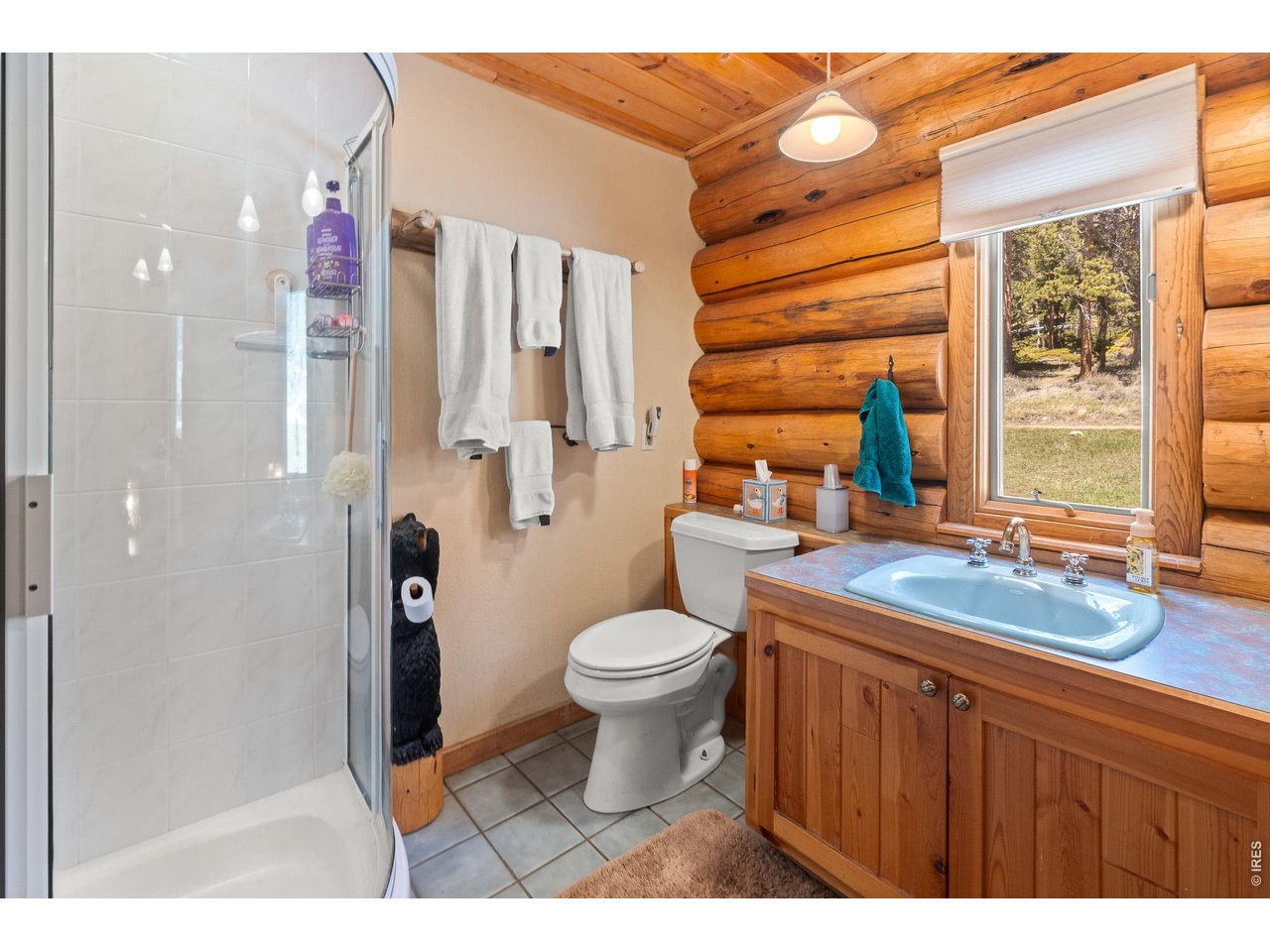 Warm & inviting beautiful log home with outstanding views of snowcapped mountains & Crystal Lake, situated on lovely 3.27 acres adjoining open space. The open-concept main level, with high vaulted ceilings, creates flow between the kitchen, dining, & living area making it ideal for entertaining, relaxing by the fire in the wood stove, or soaking in the beautiful view on the spacious covered deck. Stainless steel appliances, gas range, plenty of cabinetry, and center island make this kitchen a chef's delight. This cabin is thoughtfully designed with a bedroom & bath on each level. The spacious loft & office nook opens to its own private covered balcony to embrace the fresh mountain air or star-filled night skies. The lower-level walk-out features a large family room, 3rd bedroom & bath, utility/laundry room & access to a flagstone patio outside. Beautiful tall pine, circle drive, oversized 2 car garage (816sf!) with a workshop plus a large shed for extra storage round out the amenities of this awesome property. Frequent wildlife sightings include deer, elk, turkey & coyote just to name a few! The HOA provides road maintenance, snowplowing, acres of open space & stocks the reservoir & several smaller lakes within the Crystal Lakes community. Fish or hike in Crystal Lakes or nearby National Forests or just relax in the beauty that surrounds you. Stores & restaurants in the Village of Red Feather Lakes are just minutes away. TURNKEY- most furniture and furnishings included! Come see it today and make this your very own mountain home or weekend retreat!