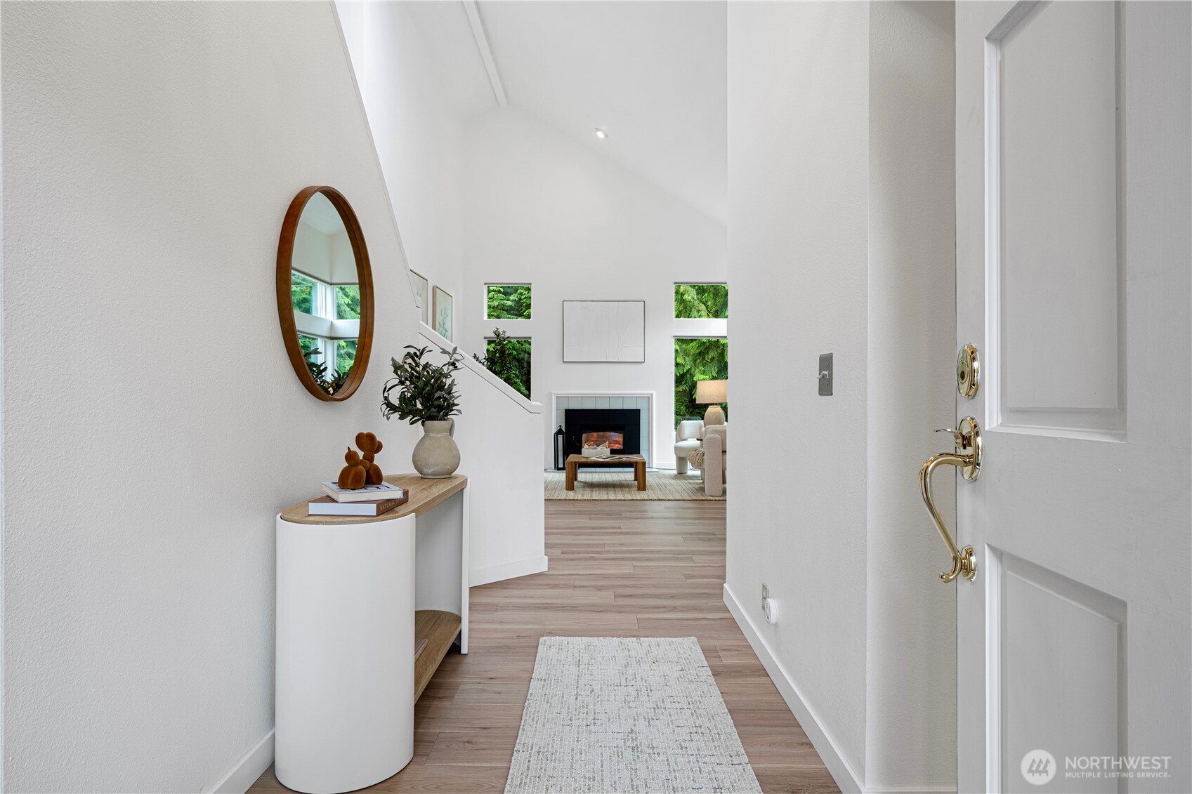 Move-in ready! $50K upgrades include new flooring, fresh paint, new EV charger, new heat pump, new combo washer/dryer, etc. This beautifully updated 3-bedroom single-family house is nestled on a quiet cul-de-sac and filled with natural light throughout. Featuring soaring vaulted ceilings and a cozy gas fireplace, the open living and dining area is perfect for both relaxing and entertaining. Nice kitchen w/eating area. Large primary suite on main floor with a luxurious 5-piece bathroom & walk-in closet.  Upper-level features two bedrooms and a full bathroom. Excellent location close t oI-405 access.