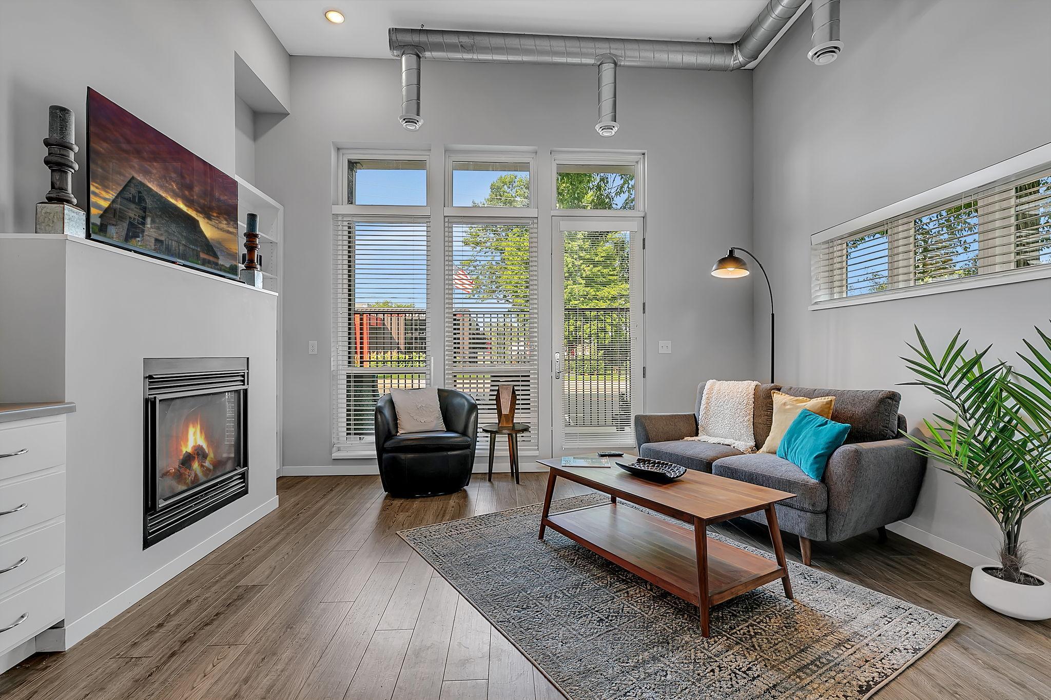 **Incentive - Go Under Contract For Purchase In 2026 And A Garage Stall Will Be Included!** Welcome to 24 North Lofts in sought-after downtown St. Joseph. This luxury condo offers impressive style and convenience, with parking lot access included and attached or detached garage spaces available for purchase. Set on the ground floor, this walk-up loft provides direct access from College Avenue and the inviting feel of a gated brownstone. The private patio features a lockable entrance gate and wrought-iron-style high railing for added security. Inside, nearly 13-foot loft ceilings create an open, airy feel above the connected dining, kitchen, and living spaces. A compact 4-foot-high balcony with ladder access offers extra storage or a playful hideaway for kids. Just steps from some of the area’s best shopping and dining, this warm, open-concept living and dining space works beautifully as a primary residence or a rental when you’re away. Enjoy convenient access to nearby parks and trails, along with shared amenities including a fitness room, rooftop deck, and elevator, all partially powered by rooftop solar panels. Worry-free luxury condo living awaits—schedule your showing today!