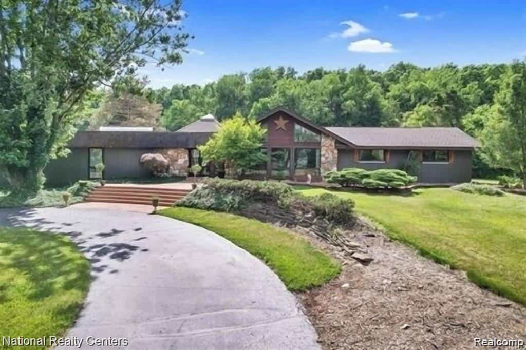 Nestled on 10 beautiful, wooded acres, this lovely home offers 5 bedrooms, 3.5 bathrooms, an indoor pool and sauna!! With nearly 5000sqft this ranch estate offers an excellent open space for entertaining any occasion. The entire home has been refinished top to bottom.  Every room has its own uniqueness with no spared expense.  Vaulted ceilings with shiplap, skylights throughout, double sided ethanol fireplace, ceramic tile heated floors in every bathroom are just a few of the special details to see.   Outside is a full basketball court, as well as plenty of room for horses, as was previously used for horse farm.  There is a Tesla EV charger in the garage.  Located just outside of the GM Proving Grounds and just a short drive to Downtown Milford, this is truly a must see!  Buyer and buyer's agent to verify all information.  Home is agent owned. Furnished to the nines, with all the new furniture and decor negotiable.  Motivated Sellers!