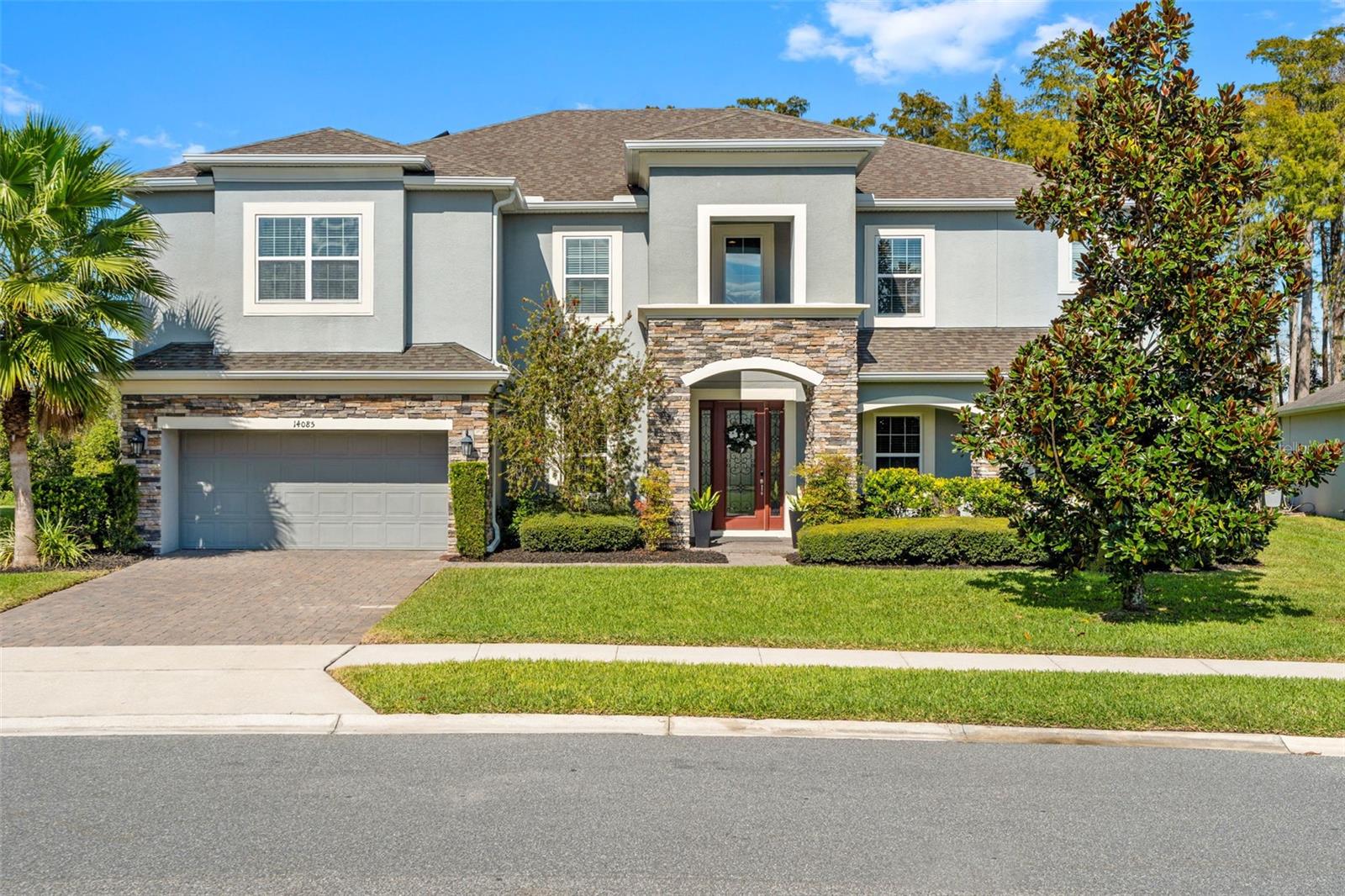 In the sought-after Cypress Reserve community of Winter Garden, this six-bedroom, four-bathroom residence embodies the art of living beautifully. With two primary suites, a theater and media room, an upstairs library/homework room  that could easily serve as a seventh bedroom, and an expansive loft, the layout delivers effortless flexibility for how modern families gather, work, and unwind.
Set on an angled conservation lot for enhanced privacy, the home’s stone-accented façade and manicured landscaping create timeless curb appeal. Inside, natural light fills the open-concept plan anchored by a chef’s kitchen featuring GE appliances, a gas cooktop, double ovens, quartz countertops, and a spacious island ideal for both prep and entertaining. A front office offers a polished workspace, while a cozy formal living room and motorized blinds in the main living area elevate both comfort and design.
The thoughtful layout includes a primary suite and guest suite on the first floor, each designed for ease and privacy. Upstairs, another primary suite joins three additional bedrooms, the loft, library or den, and dedicated theater room, ensuring there’s a perfect place for every part of daily life.
In the family room, triple pocket sliders open fully to merge indoor and outdoor living, creating a seamless transition to the resort-style backyard. The panoramic-screened enclosure frames unobstructed conservation views, offering a serene backdrop for your heated pool and spa. The outdoor kitchen, complete with grill, sink, and refrigerator, sets the stage for effortless entertaining from sunrise to sunset.

Function meets finesse with solar panels to offset utility costs and a three-car tandem garage equipped with full air conditioning, insulated doors, and a mini-split system for year-round climate control, ideal for a gym, studio, or workshop.
Situated within minutes of SunRidge Elementary and Middle Schools, the Winter Garden Farmers Market, Downtown Winter Garden, and Winter Garden Village, this location balances convenience and calm with easy access to the Turnpike and 429 for seamless commutes.
Life here blends luxury, privacy, and connection and where every sunset reminds you, you’ve arrived.