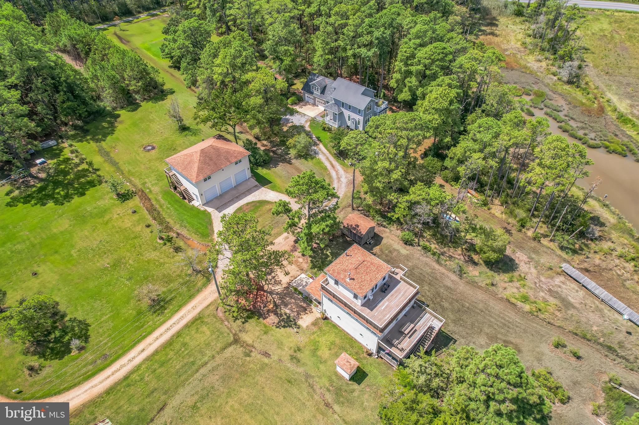 ******HUGE PRICE DROP!!!!!********* This well-maintained, three-story Waterfront home on Tanners Creek  offers a spacious and versatile layout.  Three levels of living space including 3 bedroom 3 bath.  The main level features 2 bedrooms, 1 full bathroom, a living room, a kitchen, and a dining area. The upper level includes a primary bedroom with a full bath, while the lower level offers a kitchenette with a large pantry, a family room, and 1 full bath. Both the main and lower levels have been freshly painted. All three levels have exterior access to each level of the home with large deck areas for maximum water views. A spiral staircase connects all three levels, adding charm and character. The home and detached garage have recently been power washed, and the pier was rebuilt in 1993.Situated across the street on a separate lot, the impressive garage spans over 2,500 sq ft across two climate-controlled levels and provides ample parking. Garage door openers were installed in 2007. A shed in the backyard conveys with the property, and French doors were added to the lower level in 2008. The generator, purchased in 2009, is also included.Square footage is based on tax records and may not be accurate. The home sits on a 0.20-acre lot and features large decks on both the main and upper levels, as well as a screened-in porch ideal for summer gatherings. A new oil tank was installed in 2019, and the heating/AC system was replaced in September 2018. The septic system was pumped in March 2025.This sale includes four separate lots with separate tax id #'s which will be provided in disclosures. Please note: the property is located in a flood zone, and two TDRs (Transferable Development Rights) do not convey with the sale.Less than 1/2 mile to Point Lookout State Park;