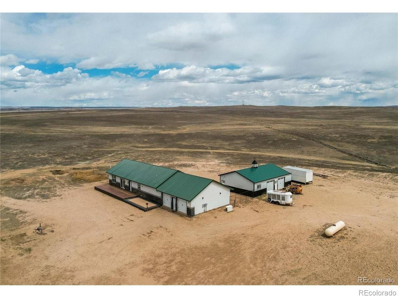 Mountain views * acreage * fully fenced * off-grid home * 30x40 shop plus oversized 3 car garage space * horse property * Colorado living! Experience true independence with this 100% off-grid property designed for comfort, functionality, and wide-open space. Situated on expansive, fully fenced 96 acreage (divided into 3-30-acre fenced sections), this property is ideal for horses, livestock, or anyone seeking privacy and room to roam, all with unobstructed mountain views. The home features 3 bedrooms plus a dedicated office, 2.5 bathrooms, and a spacious laundry room. Inside, you'll find hardwood floors, granite countertops, a butcher block island perfect for gathering, knotty alder trim, shiplap accents, and upgraded lighting throughout. This home feels elevated. Enjoy energy efficiency and reliability with a solar-powered system, brand new batteries (2025), a 1,000-gallon owned propane tank, backup Generac generator, and two wells providing dependable water access. Car enthusiasts and hobbyists will appreciate the oversized 3-car attached garage plus an additional 1,200 sq ft shop with space for up to 4 vehicles, along with ample room for RVs, boats, and recreational equipment.