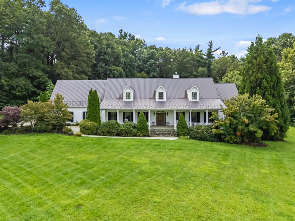 Experience refined mountain living in this extraordinary 6,201 sq ft estate in the heart of Meadows of Dan, VA. Nestled on 3.98 acres and adjoining protected Blue Ridge Parkway land, this mansion offers privacy and elegance just 4 miles from the iconic Mabry Mill, 3 miles from Nancy's Candy, and only 10 miles from world-class Primland Resort. Meadows of Dan is a vibrant yet peaceful community, where fresh mountain air, scenic parkway views, and a slower pace of life meet modern convenience. Within 2 hours you'll reach Roanoke, Winston-Salem, Greensboro, and Charlotte, all with major airports, cultural attractions, and shopping.  Designed with comfort and accessibility in mind, the home features a handicap-accessible layout, 10 ft ceilings, custom moldings, and expansive living spaces ideal for entertaining. A sweeping front porch welcomes you, while the grand back patio with stone fireplace sets the stage for outdoor gatherings. The gourmet kitchen includes double ovens, custom cabinetry, a butler's pantry, and sunny solarium, opening into the elegant living area with fireplace and access to covered outdoor living.  The main-level master suite spans nearly 1,000 sq ft, with fireplace, private outdoor access, fitness/office/tanning room, luxury bath with tiled shower, jetted tub, walk-through closet, and private laundry. Guest suites, a custom library, 3rd full bath, and 3-car garage with workshop complete the main floor. Upstairs offers 9' ceilings, 2 additional bedroom suites, a spacious living/dining/work area, 3rd laundry, and abundant storage.  Extras include: 3-zone HVAC, whole-house generator, dual water heaters, security system, an additional 1,000 sf garage, and crushed marble drive. Surrounded by open lawn and wooded privacy, this is a rare chance to own a true Blue Ridge Parkway estate.