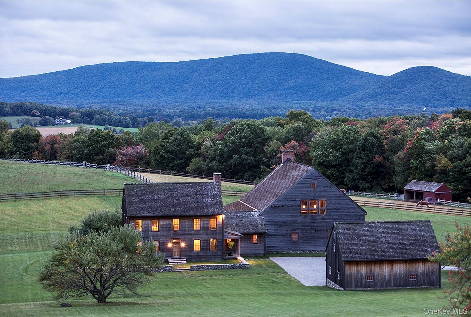 Set among the beautiful rolling hills on 203 acres is this private estate that takes you back in time. The farm was built in 2008 around a c.1754 Dutch barn that was dismantled from upstate NY and transformed into an incredible great room with 34' soaring ceilings, a brick fireplace and two huge French doors to take in the view. Designed by Cynthia Filkoff with 6,340 square feet, the main house offers five bedrooms and three and one half baths. The home feels centuries old, with the wide board floors and plaster walls throughout, while providing the modern conveniences, like the geothermal heating and cooling system and the automatic generator. Every room is a piece of art and history; comfortable, primitive and functional. Adding to the list of amenities is a two-car garage with loft; three bedroom caretaker’s house; and equestrian facilities including a five stall barn, equipment barn, outdoor riding ring and six paddocks. The expansive property has trails throughout and was placed in the Dutchess Land Conservancy for love of the land. A once in a lifetime opportunity to purchase this private country estate. Just minutes to Pine Plains, and two hours to NYC. Additional Information:  Amenities:Soaking Tub,ParkingFeatures:2 Car Detached,