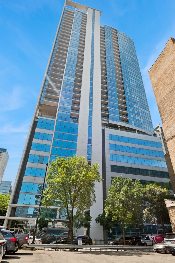 Welcome to Residence 1507 at the Silver Tower! Stunning Corner 2BD + Den or Office Space with Balcony & Iconic City View | a sleek home showcasing jaw-dropping skyline and sunset views. The home features wrap-around floor-to-ceiling windows from every room and a massive 25-foot south-facing private balcony and west-facing sunsets. Designed for modern living, the open-concept layout with split bedrooms. This luxurious home features a chef-inspired kitchen with rich walnut cabinetry, granite countertops, and premium stainless steel appliances. The expansive living space flows effortlessly, ideal for entertaining or relaxing above the city. The primary suite offers a spa-like escape with a double vanity, walk-in shower, and generous closet space. The versatile den easily functions as a home office, fitness nook, or formal dining area-your lifestyle, your call. Additional highlights include: Wide-plank hardwood floors, In-unit washer & dryer, and Extra storage included. Enjoy life at Silver Tower, a full-amenity high-rise offering:    24-hour door staff, State-of-the-art fitness center, Dog run, Skyline rooftop deck with grills & lounge seating, and Unbeatable River North location, steps from the L, expressways, top-tier restaurants, and nightlife.   Indoor heated parking spot available for $35,000.