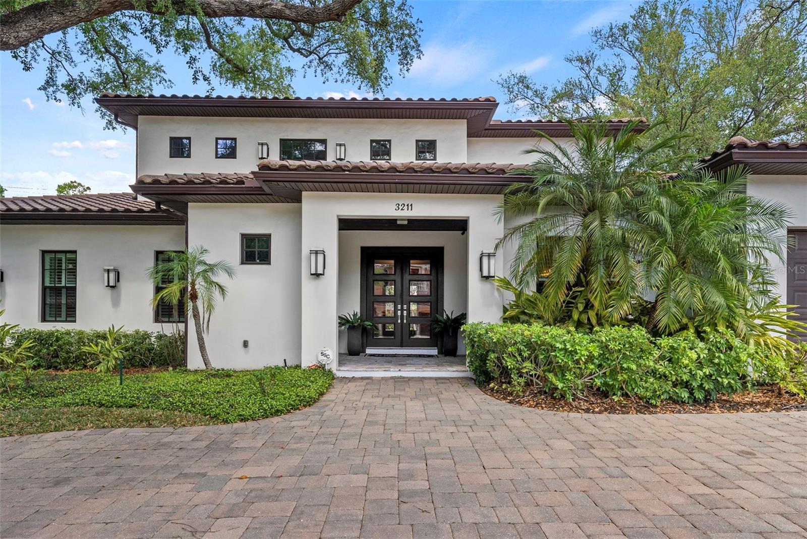 Welcome to this stunning 5-bedroom, 4.5-bathroom pool home in the highly sought-after Bayshore Beautiful neighborhood. Designed for both everyday living and effortless entertaining, this home is enhanced by soaring 10-foot ceilings, plantation shutters, and thoughtfully selected finishes throughout. Two brand new AC systems have recently been installed, providing peace of mind and energy-efficient comfort year-round. The main level primary suite is privately situated on one side of the home, while an additional guest suite is positioned on the opposite side, offering ideal separation. Between them, the quiet living room—complete with a cozy gas fireplace—and the spacious kitchen create a natural buffer while still maintaining a seamless flow. Additional features on the main level include a dedicated office, half bathroom, and a well-appointed laundry room. Upstairs, you’ll find a generous loft-style living area along with one private en-suite—perfect for guests or multigenerational living—as well as two additional bedrooms and a hallway bathroom. Step outside to your private backyard oasis and enjoy true indoor-outdoor living. The enclosed lanai, equipped with phantom screens, allows you to open up the space to the outdoors while maintaining comfort and versatility year-round. Beyond, a saltwater pool, full-size outdoor kitchen, and fire pit create the ultimate setting for relaxing or entertaining. Completing the home is an oversized two-car garage offering ample storage and functionality, along with a semi-circle driveway that provides additional parking. This home perfectly blends comfort, style, and location—an exceptional opportunity in one of South Tampa’s most desirable neighborhoods.