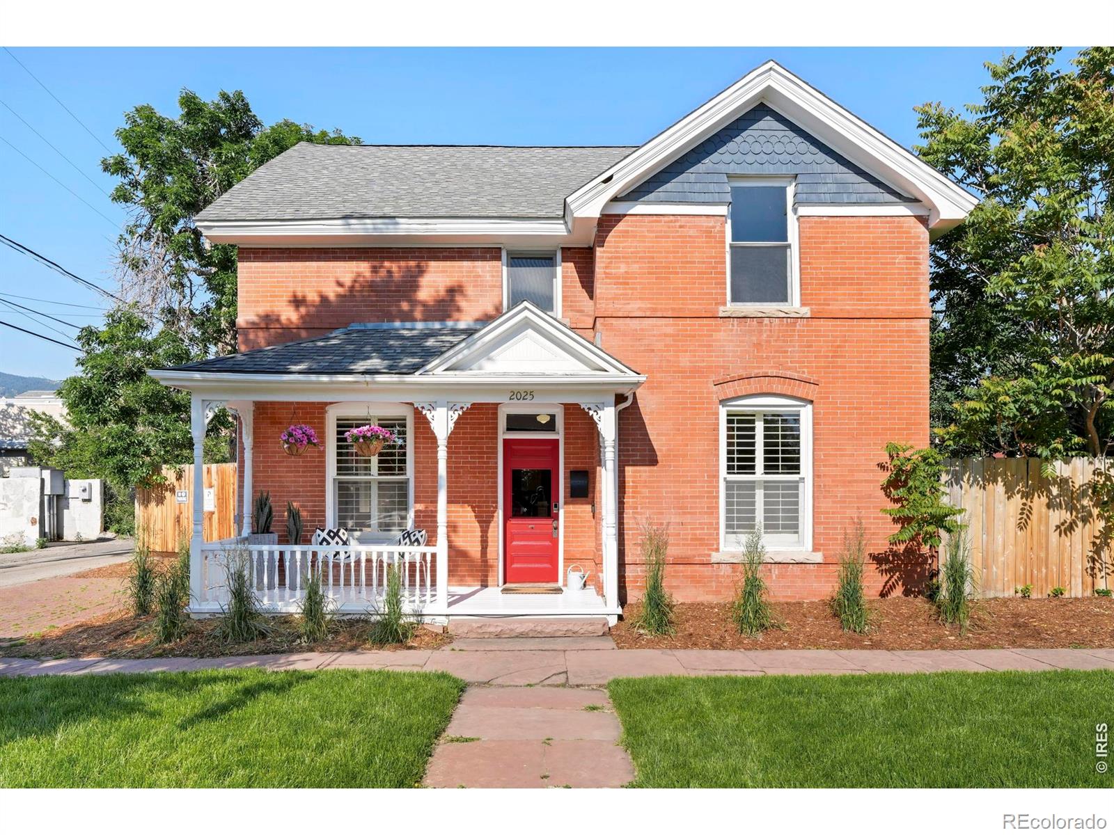 Situated just one block from Pearl Street yet tucked away on a quiet, tree-lined street, this iconic Queen Anne brick home offers a rare and exceptionally valuable opportunity to own a piece of Boulder's history in an unbeatable downtown location. Walk to Boulder's most celebrated restaurants, cafes, and shopping-including Michelin-starred dining at Frasca-just steps from your door, all while enjoying the serenity and privacy of a peaceful residential enclave. A covered front porch welcomes residents into a home rich with character, where original hardwood floors, tall ceilings, and detailed millwork evoke a sense of timeless elegance. The cozy front parlor, complete with built-ins + fireplace, flows seamlessly into a dining area framed by exposed brick & onward to a sun-drenched flex room. Upstairs, vaulted ceilings + warm wood floors continue the historic charm across three light-filled bedrooms. A clawfoot tub + pedestal sink add a vintage touch to the updated bath, thoughtfully curated to preserve the home's authenticity while offering modern comfort. Unusually spacious for a downtown lot, the private backyard boasts a large mature shade tree, a flagstone patio, + built-in BBQ. Includes 1-off-street parking spot plus 22'x17' eastern bay of the barn & 17'x7.5' western portion of barn which may be restored for small car garage use w/some structural repairs. Barn structure has 3 sections & neighbors have use & access easement for the middle portion of barn. Buyer to verify w/City of Boulder on potential for all modifications & improvements. Seller makes no guarantees, Buyer to verify all info.