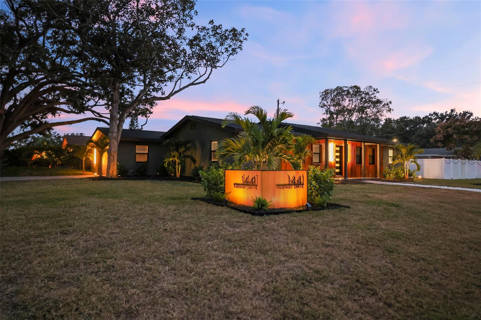 Welcome to this one-of-a-kind, fully remodeled showpiece in highly sought-after Fairway Estates on a quarter of an acre. This corner-lot home offers almost 2,000 heated square feet of modern luxury with 4 bedrooms, 2 full baths, and a spacious 2-car garage — all wrapped in designer finishes and thoughtful touches you won’t find anywhere else.Step inside and immediately feel the quality of a fully permitted remodel from top to bottom. The stunning new kitchen features quartz countertops, Samsung Bespoke appliances, soft-close custom cabinetry, and a large pantry. The dining room showcases a custom-built bar with shelving and a mini fridge, creating the perfect space for entertaining. With two generous living areas and an open flow from kitchen to dining, this home is truly made for gathering.Every detail shines — from new hurricane-impact windows (2025), to gorgeous luxury vinyl flooring, to recessed lights in every room with adjustable settings for the perfect ambiance. The primary suite is a serene retreat with a large updated en-suite bath, oversized vanity, and a custom walk-in shower.Outside, enjoy a large fully fenced yard, a paver patio, and room for outdoor living at its finest. Major updates give you peace of mind, including new electrical, new plumbing, a new mini split A/C system, and a 2025 roof.Location is everything, and this home places you just a short walk to the newly renovated Dunedin Golf Club and beautiful Lake Saundra. Grab your golf cart and head downtown to enjoy Dunedin’s restaurants, shops, festivals, and charming coastal lifestyle. Fairway Estates offers a peaceful, established neighborhood with no flood insurance required.Move-in ready, beautifully redesigned, and truly unmatched — this is the Fairway Estates home you’ve been waiting for.