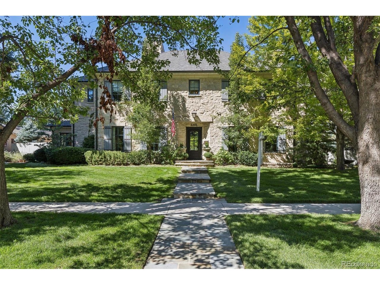 Set on a rare 15,900 SF lot in Observatory Park, this stone French country residence was built by AJ Kirkegaard Contractors with architect Stephen Hentschel. A cut bluestone walk leads to a steel and glass entry and handmade Francoise Italian tile. Inside: wire-brushed French oak floors, reclaimed beam work, Eron Johnson architectural doors and an elevator to all three levels. The chef's kitchen pairs Wolf and Sub-Zero appliances with Plato cabinetry, a custom hood and a statement wood island. Three ensuite bedrooms up, including a primary bath with Ann Sacks arabesque heated floor, antique mirrored closet and copper soaking tub. The lower level adds a fourth ensuite bedroom, a Full Swing golf simulator and entertaining space finished to match. Outside, a steel and wood trellis shelters dining and living areas beside two Nisho fire pits and a built-in BBQ, with mature landscaping and room for a pool. Three-car garage with heated 575 SF studio. Walk to the park, DU and University Blvd.Call agent for showing appointment. 303-818-8668SELLER IS A LICENSED REAL ESTATE BROKER IN THE STATE OF COLORADO