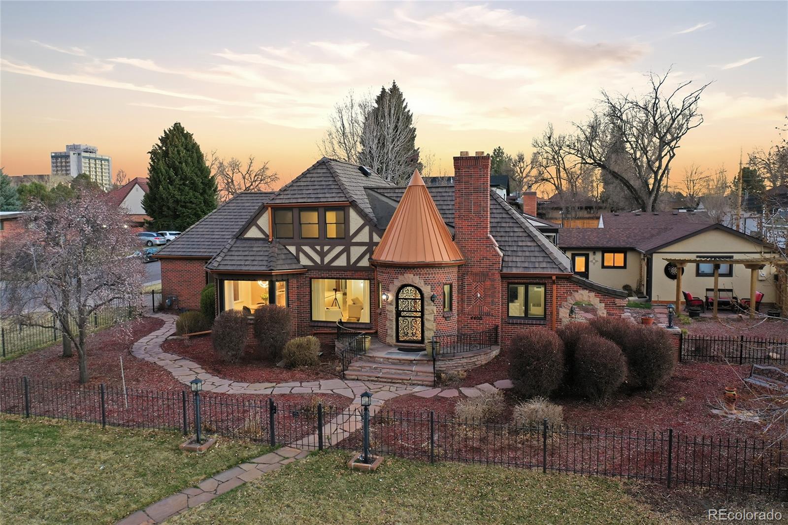 ABSOLUTELY GORGEOUS LAKEFRONT HOME W/ DETACHED GUEST HOUSE * Directly across from Sloan's Lake Park * Professional landscaped 12,500 sq ft lot includes outdoor kitchen, gas firepit, stamped concrete patios and multiple entertaining areas! * Exquisite oak hardwood floors throughout home * Incredible high-end kitchen opens to beautiful living and dining areas surrounded by large windows overlooking the lake * Renovated kitchen features brand new white oak cabinetry, a stunning 9-foot marble stone waterfall breakfast-bar island, copper tile backsplash, commercial-grade appliances, a touch faucet, a flush-mounted vent hood designed to maintain open views and clean sightlines, huge pantry and a bar/coffee area complete with a wine fridge and additional storage * Bathrooms include Toto toilets and heated floors in the upstairs primary ensuite bathroom. Several first-floor windows have also been replaced * Additional updates include renovated living and TV rooms, an updated laundry room with utility sink, and a beautifully updated double-sided fireplace with new stone on each side * Built-in entertainment features include ceiling speakers in the living room, a speaker system in the TV room, and an outdoor TV and speaker setup on the patio * Great opportunity to re-enclose where a main floor bedroom had been and easily add another bedroom *  Functional upgrades include new AC, new tankless hot-water heater, whole-home water filtration, insulated main garage, sealed garage floors, sprinkler system, and easy-to-maintain landscaping * Enjoy Sloan's Lake and all its amenities including excellent trails, tennis courts, bird watching, playgrounds, picnics  & fitness classes * Easy stroll to Cholon ,Gusto, Alamo Drafthouse, Stoney's, Bowls, Edgewater Marketplace, Breweries, Little Man Ice Cream and more! 10 minute walk to Light-Rail Station(s)..DIA, DTC & Union Station. Easy access to Downtown Denver, I-25, Hwy 6, Highlands and Mountains! Welcome to your Castle on the Lake!!