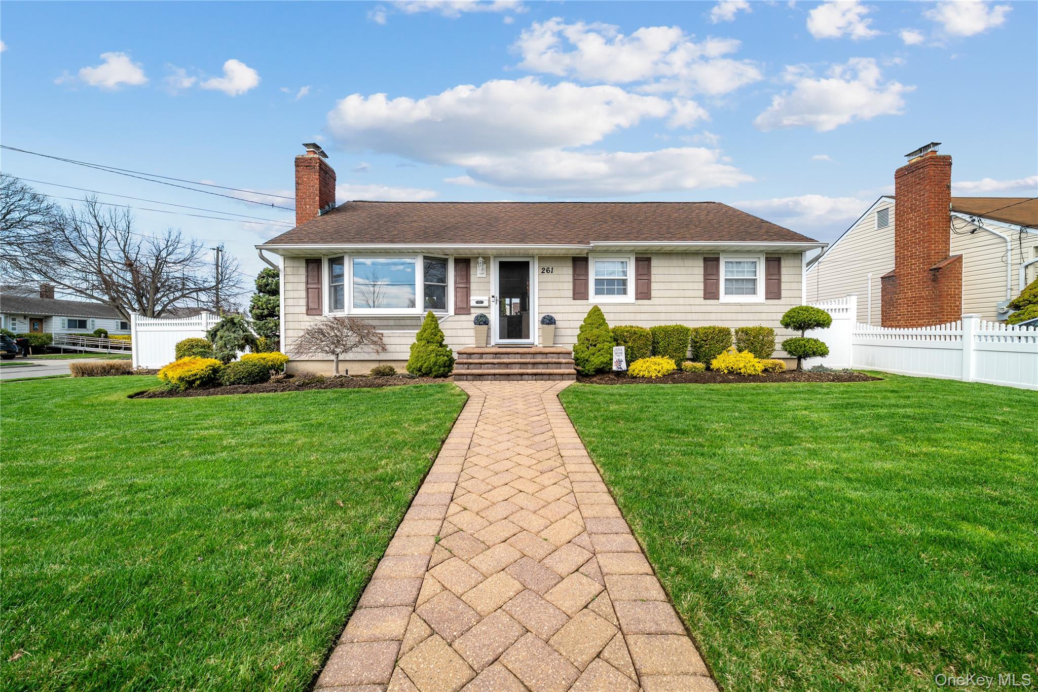 Welcome to this one of a kind, fully renovated Bethpage beauty, offering a spacious open floor plan with 2/3 bedroom and 2 baths. From the moment you step inside, you'll be captivated by the stunning cathedral ceiling with exposed beams and subtle hidden lighting, creating a warm yet dramatic ambiance.  The inviting living room features rich hardwood floors, a wall of windows that flood the space with natural light and a striking iridescent mosaic tiledwood burning fireplace as its centerpiece. The living room flows seamlessly into a bright sunlight dining area, which wraps effortlessly in the beautifully designed kitchen, perfect for both everyday living and entertaining.  The open concept kitchen boasts cherry wood cabinetry, granite countertops and sleek porcelain tile flooring, all complemented by stainless steel appliances. At the rear of the home, custom triple pane sliding glass doors invite abundant sunshine while providing a seamless connection to the outdoor, enhancing the home's airy, open feel. The hardwood floors continue seamlessly down the hall to the bedrooms. The primary bedroom has been thoughtfully created by combining two rooms into one spacious retreat.  It features two closets and offers ample space for additional furniture or a comfortable sitting area. The highlight of the home is the fully finished lower level which showcases a PROFESSIONALLY designed home gym (equipment sold separately) with two large egress windows that allow an abundance of natural sunlight to fill the space. This space can be used as a movie theatre, playroom, downstairs den, in law suite  etc.  Adjacent to the gym is a bathroom with ample room to add a shower offering great potential for a complete wellness area. The outside of the home features a spacious Trex deck, enclosed by durable PVC fencing that extends around both the deck and the perimeter of the property for added privacy. The standout bonus is the converted garage, thoughtfully designed with carpet ,exposed beams and LED lighting.  Fully SOUNDPROOFED and equipped with both heating and air conditioning, this versatile space is ideal for a music studio, art studio, podcast room , yoga studio, dance studio, home office or any creative use you can imagine.This exceptional home features countless additional features beyond what is listed-schedule a private showing to truly appreciate all it has to offer.
