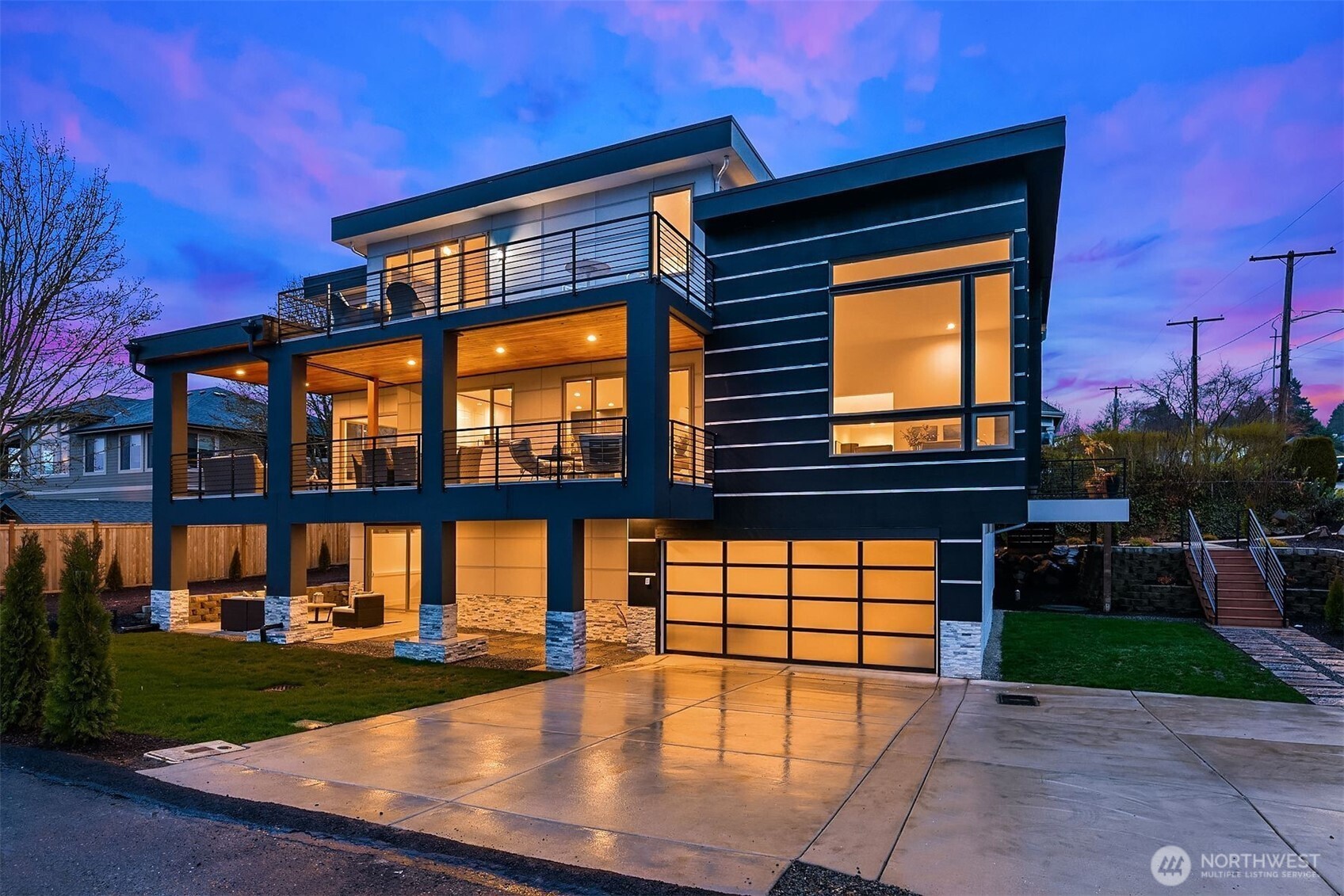 One of Kennydale's premier modern view homes—offering Lake Washington views, multiple ensuite bedrooms, a true entertainer's layout, and the convenience of Bellevue and Seattle just minutes away.Thoughtfully designed 5-bedroom, 5.5-bath residence offers flexibility, comfort, and an ideal layout for modern living, featuring a desirable main-floor bedroom suite, dedicated home office, and separate flex space perfect for a playroom, study area, sitting room, or additional workspace. The main floor features open-concept living and dining areas with soaring ceilings, abundant natural light, and access to a wraparound view deck. The kitchen centers around a large island and flows effortlessly into the living spaces. Upstairs, the primary suite enjoys a private balcony with lake and city views, plus a spacious bath and walk-in closet. Two additional ensuite bedrooms, a versatile loft, and upper-level laundry complete the floor. The daylight basement offers a media room, game room, full bath, laundry area, guest accommodations, and flexible space for a gym, hobby room, or extended living. Sliding doors open to a covered patio. Additional features include air conditioning and a 3-car tandem garage. Conveniently located minutes from I-405, Lake Washington parks and boat launch, The Landing, Bellevue, Boeing, Sea-Tac Airport, and downtown Seattle. A rare opportunity to own a spacious view home in one of Renton's most desirable neighborhoods.