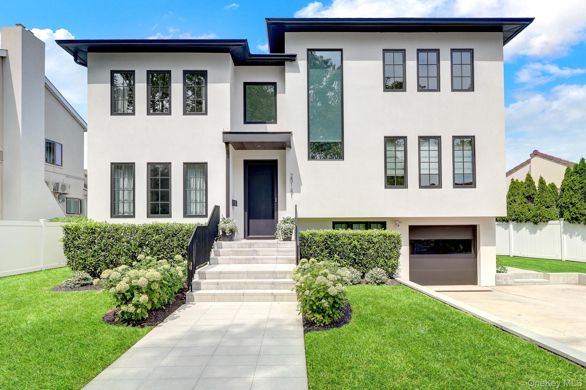 Welcome to this exceptional, recently built home in the highly desirable Little Neck Hills neighborhood. Thoughtfully designed to blend timeless architectural style with modern luxury, this impressive residence offers beautifully appointed living spaces, high-end finishes, and exceptional amenities throughout.The inviting living room flows seamlessly into the formal dining room and features direct access to the backyard, creating the perfect setting for indoor-outdoor living and entertaining. The kitchen is equipped with top-of-the-line stainless steel appliances, extensive custom cabinetry, modern finishes, and a large center island offering both style and functionality.The second level features a luxurious primary en-suite with a marble full bath and custom-built California closet. This level also includes an additional bedroom with a custom-built closet and another full bath.On the second floor, there are two generously sized bedrooms, an additional full bath, and a spacious, modern recreation room designed for both comfort and functionality.The fully finished lower level extends the living space with a recreation room, full bath, and sliding doors leading directly to the backyard. The completely finished basement offers additional versatility with a children’s playroom, laundry room, and utility area. *** The home's versatile layout offers exceptional flexibility for multi-generational and extended family living ***Additional features include radiant heated floors throughout, electric window shades, a one-car garage, electric vehicle charging station, in-ground sprinkler system, whole-house generator, gas barbecue connected directly to the gas line, and a pergola perfect for outdoor dining and entertaining.Conveniently located near major highways, shopping, transportation, and highly regarded School District 26. This exceptional home offers the perfect combination of modern luxury, comfort, and convenience in one of Little Neck’s most desirable neighborhoods. Don’t miss this extraordinary opportunity