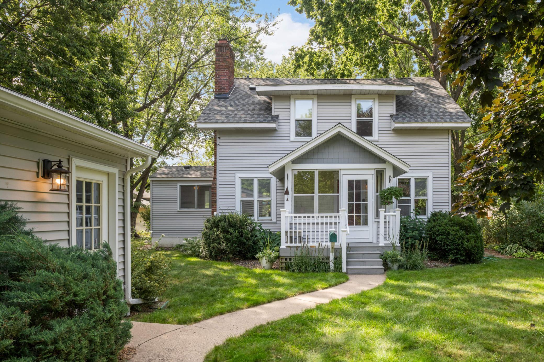 This is your chance to own a part of Bloomington's history! This former farmhouse was part of a 200 acre working farm. The home now resides on a spacious 1/3-acre city lot with mature trees offering shade and privacy. This third-owner home offers three levels of finished living space and features a newer roof, siding, gutters, boiler, and many newer windows. Enjoy the inviting 3-season front porch—perfect for relaxing, entertaining, or your morning coffee. On the main level, you'll find a large office/sunroom with French doors and a half bath, as well as a separate dining room with original built-ins—ideal for hosting or everyday meals. The upper level includes 3 light-filled bedrooms with gleaming hardwood floors and a full bath. The basement includes a second kitchen, ideal for multi-generational living, or guest use. The finished lower level has a wonderful family/game room. Add an egress window and make a 4th bedroom! Centrally located near shopping, dining, and the airport—this home offers space, character, and modern updates, all with urban convenience.