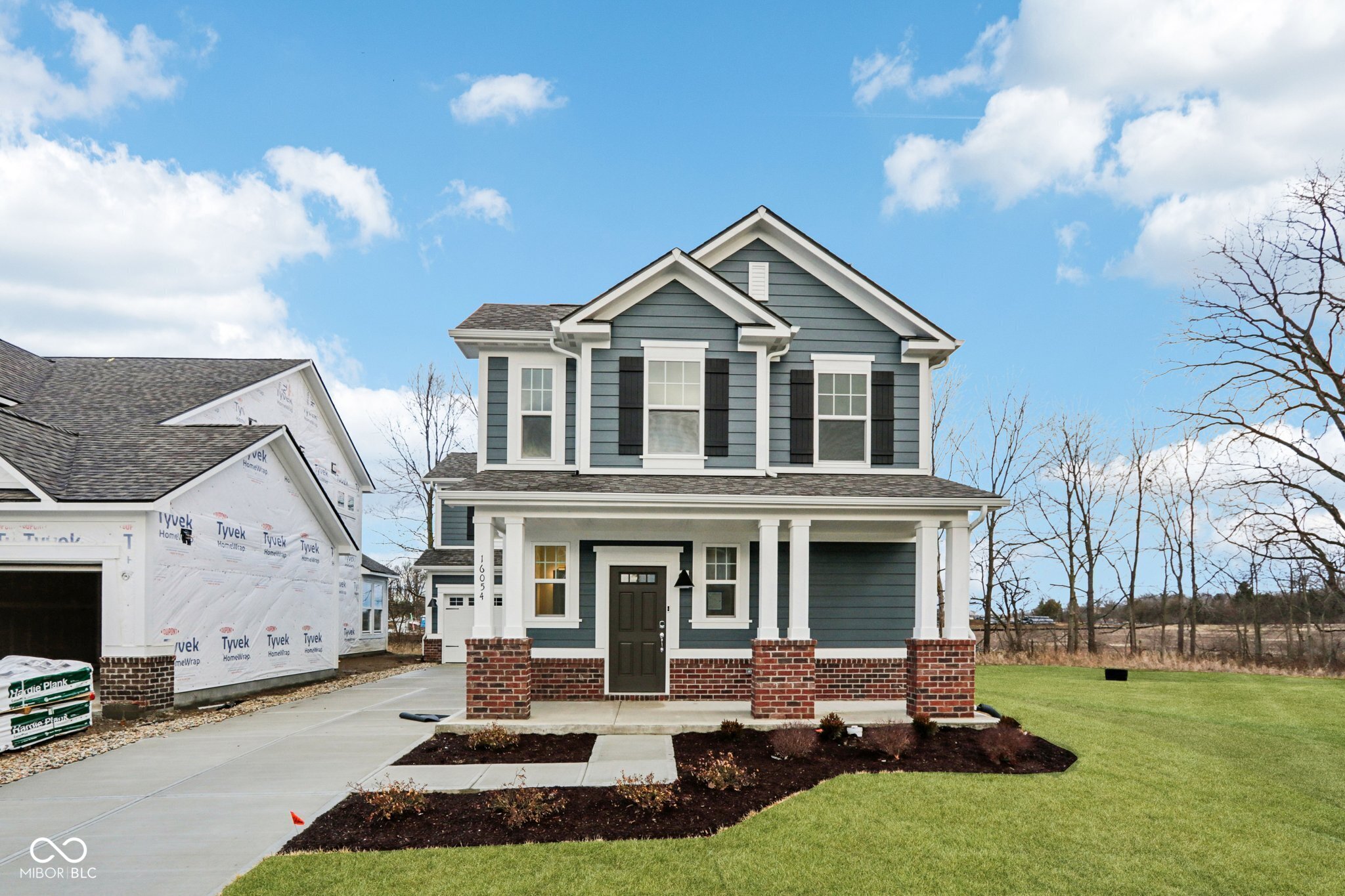 What's Special: Fireplace | Loft | Corner Lot | Cul-De-Sac Lot. New Construction - Ready Now! Built by Taylor Morrison, America's Most Trusted Homebuilder. Welcome to the Brooklyn at 16054 Meadow Frost Court in Cyntheanne Woods! A thoughtfully designed two-story home that combines comfort and style. Step inside to an inviting foyer with a convenient half bath. The open first floor features a modern kitchen, casual dining area, and spacious great room that flows to a covered patio-perfect for relaxing outdoors. A two-car garage adds extra storage. Upstairs, enjoy a versatile loft, two bedrooms, a full bath, and laundry. The highlight is the serene primary suite with a walk-in closet and spa-inspired bath. Great things are happening in Fishers, IN! Known for top-rated schools, family-friendly activities, and a warm community feel, Fishers blends historic charm with modern attractions. Explore the Fishers District for upscale dining, boutique shopping, and lively events. Additional highlights include: tiled shower with a bench in the primary bathroom, and electric fireplace in the great room. MLS#22077513