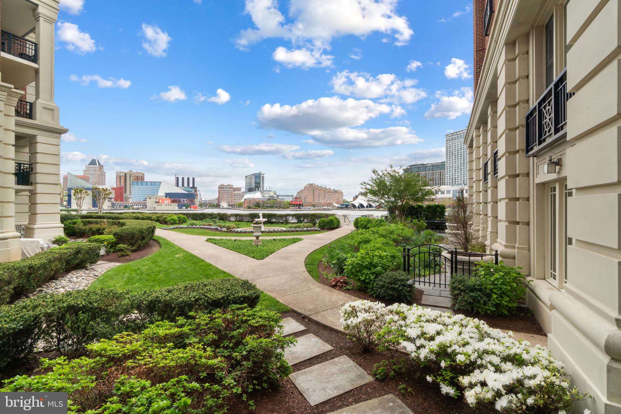 Rarely available, expansive 2-bedroom + den, 2 full and 1 half bath residence offering over 2,500 square feet, opening to an exceptional private patio overlooking the Inner Harbor. A thoughtful, well-executed layout is anchored by a gourmet kitchen with center island, premium Viking appliances, pantry, and integrated dining area, flowing seamlessly into a spacious living room with wet bar, designed for both everyday living and refined entertaining. A flexible office or den sits just off the main living space. Sliding glass doors from both the living area and primary suite open directly to the patio, creating a seamless indoor-outdoor connection. The outdoor space extends to a beautifully landscaped Ritz-Carlton garden with fountain, offering a sense of scale and tranquility. The primary suite functions as a private retreat with space for a sitting area, generous closet space including an oversized walk-in, and a luxurious, spa-like bath. The second bedroom is well-proportioned and features its own ensuite bath. Two parking spaces and dedicated storage complete the offering. Residents enjoy exclusive access to on-site fine dining, a full-service marina, and a state-of-the-art wellness spa, along with 24/7 concierge, valet, doorman, and porter services that define The Ritz-Carlton standard. Additional amenities include an indoor pool, fitness center, theater, six private guest suites, and elegantly appointed event spaces set within manicured grounds. Perfectly positioned along the Baltimore Promenade with direct waterfront access, this home is moments from water taxis, cultural landmarks, stadiums, Penn Station, and BWI Airport. Schedule your private showing today.