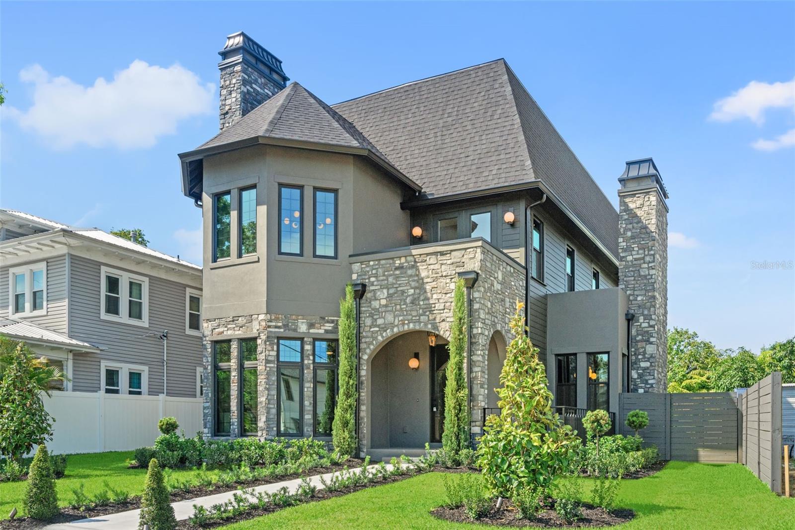 Welcome to 807 W Park Ave, a one-of-a-kind residence built by VIKIN Homes in the heart of Ridgewood Park. As seen on HGTV's 100 Day Dream Home!
This brand-new, meticulously crafted 5-bedroom, 5.5-bathroom home offers an extraordinary blend of classic design elements and cutting-edge finishes, creating a living experience unlike any other. This stunner boasts five spacious ensuite bedrooms with custom walk-in closets across three floors. Floor one is adorned with mostly common space including your two-toned designer kitchen, dining room, living room, fully built out pantry and built-in mudroom. Floor two is where you go to rest and reset by way of the primary and two separate auxiliary bedrooms. Floor three wraps’ things up by offering more sanctuary with two additional bedrooms and an oversized flex room that hosts ample cabinet and countertop space along with refrigeration. Whether you utilize it as a media room, game room or playroom, its location on the third floor will ensure its occupants aren’t disturbing anyone else in the home. Enjoy panoramic views of downtown Tampa and the Ridgewood Park Butterfly Garden from your private balcony—perfect for morning coffee or evening sunsets. Location is prime being just one block away from the beautiful Hillsborough River and the vibrant Armature Works property, offering access to Tampa's finest dining, shopping, and cultural attractions. This home blends the grandeur and charm of Gothic Revival design with modern, high-end amenities. With its towering spires, arched windows, intricate stonework, and high ceilings, it’s a rare find in the dynamic Ridgewood Park neighborhood. This is more than a home….it’s a lifestyle.

Builder currently offering to cover all closing costs!