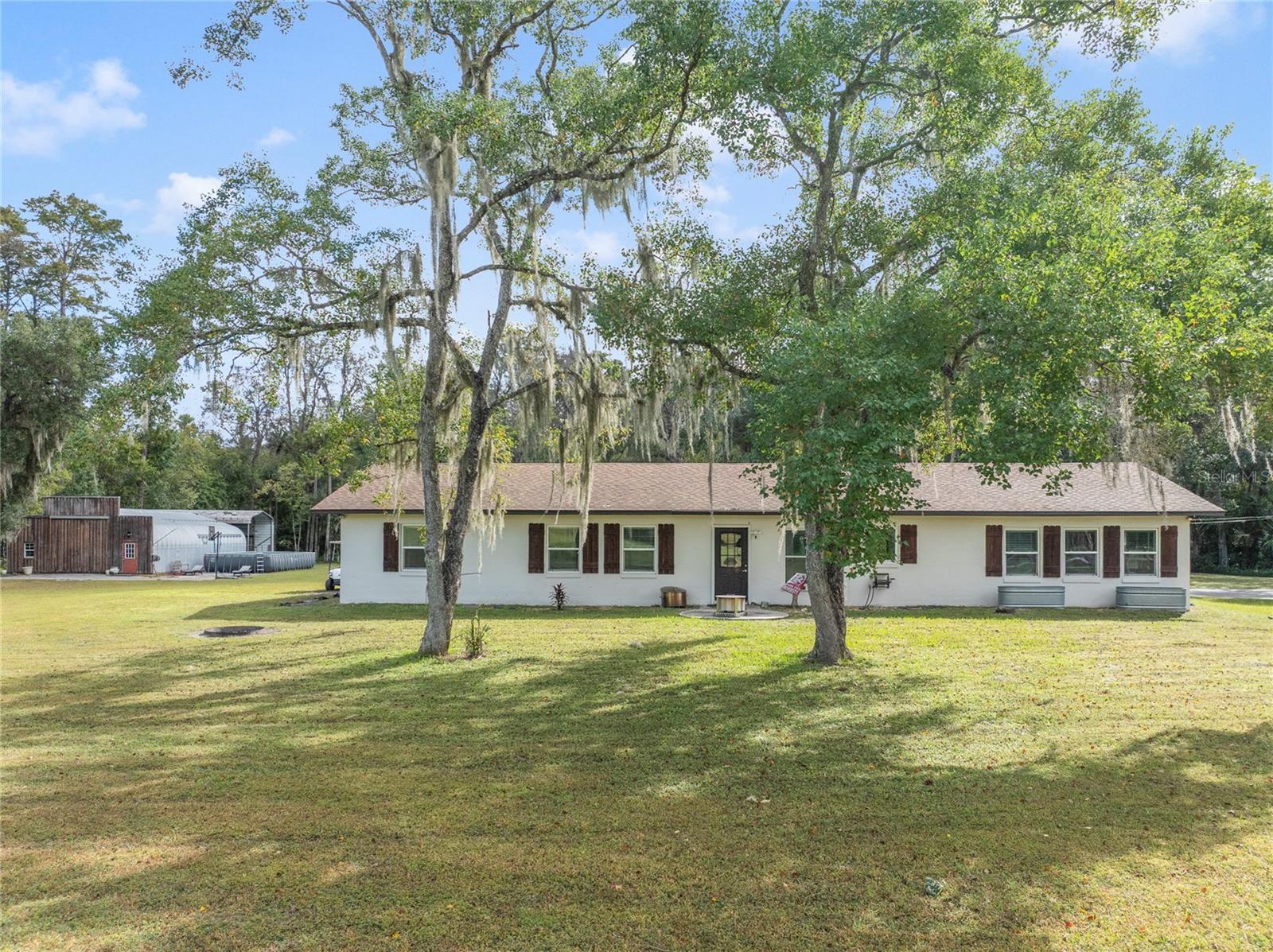 Modern Farm Retreat on 5 Acres in Gated Happy Trails – Kissimmee, FL

Discover the perfect blend of country living and modern comfort in this stunning 3-bedroom, 2-bath home located in the exclusive gated section of Happy Trails. Nestled on 5 private acres, this over 2,000-square-foot residence offers serenity, space, and sophistication just minutes from the attractions, dining, and shopping of Kissimmee.

Step inside and be welcomed by a beautifully renovated interior showcasing a modern farmhouse design—bright, open spaces, elegant finishes, and top-of-the-line appliances throughout with Quartz Countertops and extra large farm sink. Ton of storage with two walk in pantries. The home’s layout flows effortlessly, ideal for both everyday living and entertaining.

Outside, enjoy your very own private pond with a tranquil fountain, perfect for relaxing afternoons or scenic evenings under the stars by your two fire pits. The property also features a 30x50 workshop/garage, RV carport with hookups, and a fenced front and side line with a private gate for added security and convenience. Bring your livestock—there’s even an established chicken coop ready for your feathered friends and a separate garden shed.

With plenty of room to expand, garden, or build additional structures, this estate offers limitless potential for anyone seeking a self-sustaining lifestyle without compromising modern luxury.

Enjoy the peace and privacy of country living while remaining close to everything Central Florida has to offer. This one-of-a-kind property is ready to welcome you home!