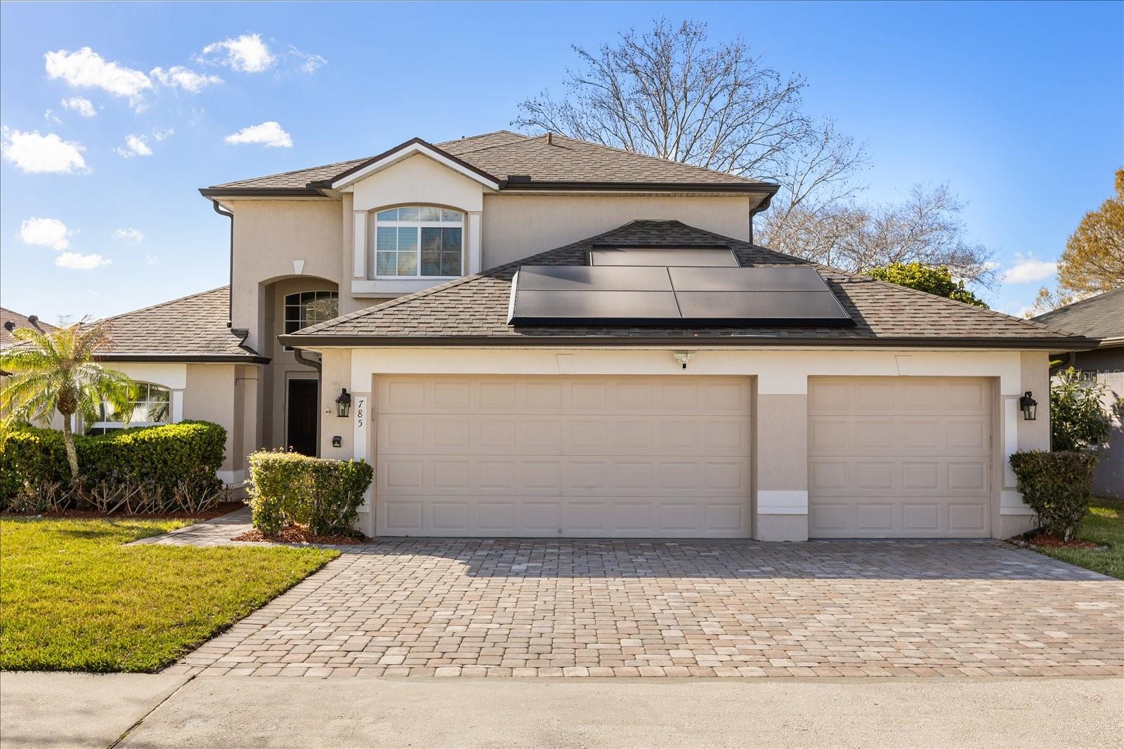 LAKE MARY POOL HOME WITH SPA - GATED - MAGIC LAKE VIEWS - PAID OFF TESLA PANELS - 2018 ROOF, 2026 WATER HEATER, 2026 AC! This charming home in Woodbridge Lakes features high ceilings and beautiful natural light.  Upon entry, you will find the soaring ceilings and ample living room space.  To your left is the dining space with views of the pool and Magic Lake, and to your left is the kitchen, featuring granite countertops, all stainless appliances, and two fridges (both included in sale.) Stepping outside to the pool area, you will find the heated pool (via gas or solar) and a heated, jetted spa!  The views alone will make you want to stay outside all day and night!  Back inside, this home features a true split floor plan, with the ensuite master bedroom on the first floor.  The bedroom is spacious and the ensuite bath has been fully renovated, featuring a beautiful standalone tub and updated shower, doubly vanity and countertops.  Back out through the living you will find, before going to the garage, the powder bath, and laundry area.  Upstairs you will find a spacious den (or 4th bed/office,) as well as two other bedrooms, and the hallway bathroom.  This home features a 3-car garage, freshly painted, fully paid off Tesla Panels, keeping your power bill very low and the seller has even received credits some months out of the year.  This community is very conveniently located off of Rinehart Road, with easy access to Lake Mary Blvd and HE Thomas. Come see this gated community home today!