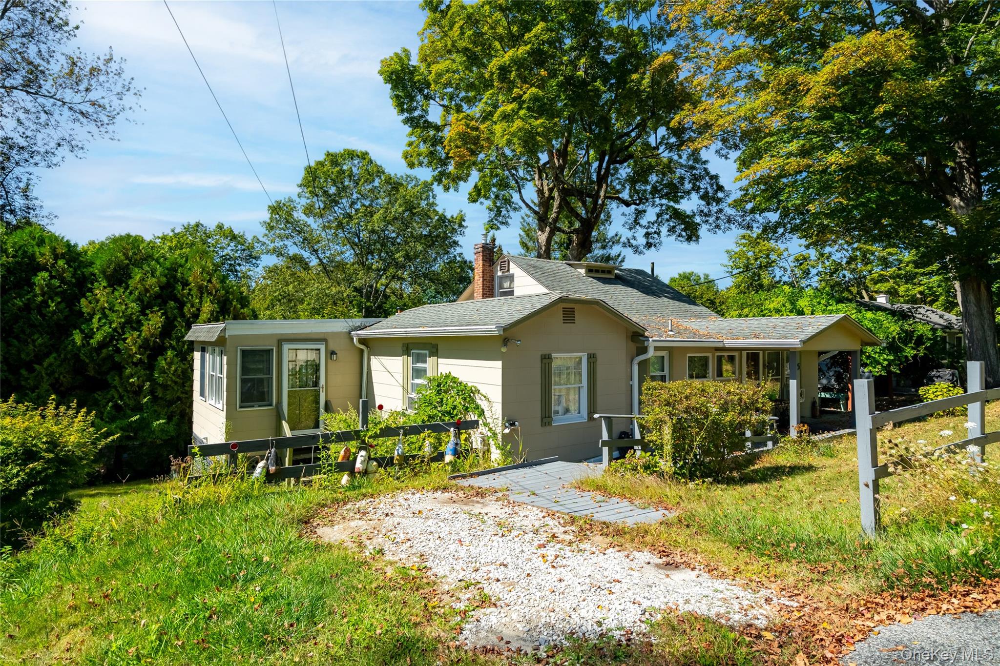 Welcome to 5 Orchard Rd, a Cozy 2-bedroom bungalow on beautiful Peach Lake. This sun-filled home offers one-level living with all the amenities Vails Grove has to offer. Looking for your first home or downsizing, look no further. 2 bedrooms, 1 bathroom, a Big Living room, and a cozy sitting room with a propane-heated fireplace. This property is located a few minutes walk to the community playground, basketball courts, boat docks, clubhouse, and community beach. Tennis and pickleball courts to be finished soon. Drive-way parking as well as community parking across the street. Minutes from Hayfields, 121 restaurant, Highways (84 & 684) as well as schools and Metro North Train.