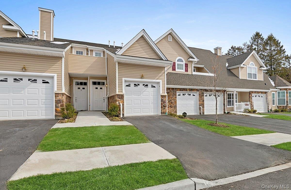 Welcome to 4 Steven Circle in Stone Ridge Estates, a gated 55+ community in Dix Hills. This newly constructed two-bedroom, two-bath residence offers a thoughtfully designed open layout with refined finishes throughout. The expansive chef’s kitchen serves as the focal point of the home, featuring abundant custom cabinetry, generous granite counter space, premium stainless steel appliances, and a spacious layout ideal for entertaining or everyday living, with a door providing direct access to a private deck for seamless indoor-outdoor enjoyment. The adjoining dining and living areas flow comfortably beneath soaring cathedral ceilings and are anchored by a gas fireplace and rich wood-toned flooring that adds warmth and continuity throughout the main living space. The primary suite provides a comfortable retreat with two large closets and a spa-inspired en-suite bath complete with a granite double vanity, expansive mirror, and an oversized corner soaking tub designed for relaxation. A well-positioned second bedroom and full bath offer flexibility for guests or home office use, while additional highlights include an in-unit washer and dryer, attached one-car garage, private driveway, and numerous quality upgrades throughout. Residents enjoy access to two beautifully appointed clubhouses featuring an outdoor pool, grand entertaining space with full kitchen, card room, library lounge with fireplace, billiard room, and fully equipped fitness center, offering a low-maintenance lifestyle in one of Dix Hills’ premier gated communities.