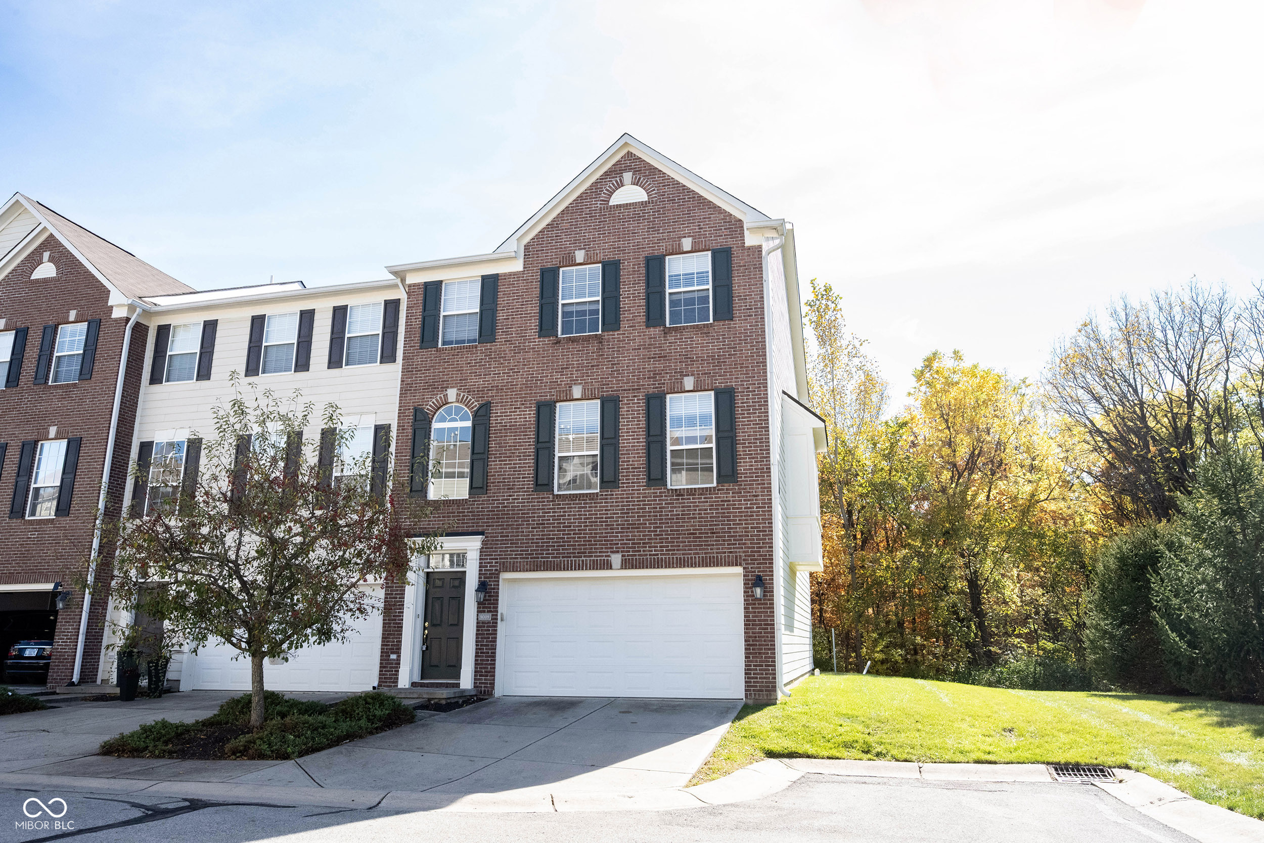 Nestled in the desirable city of Fishers, Indiana, discover the condominium residence at 9009 Mercer DR, presented in great condition.  The heart of this home resides in its thoughtfully designed kitchen, a space where culinary aspirations come to life, featuring shaker cabinets complementing stone countertops, a stovetop, and a double oven which offers the space and capability to create memorable meals. Imagine preparing meals on the kitchen peninsula in this open floor plan. The living room features a fireplace, where one can imagine gathering with friends or enjoying quiet evenings. The primary bedroom offers a private retreat with its ensuite bathroom, designed for relaxation and convenience. This bathroom enhances your daily routine with a walk-in shower and double vanity. This condominium offers the convenience of a laundry room, and the primary bedroom provides a walk-in closet. The residence also includes a balcony, perfect for enjoying fresh air, and offers the convenience of two full bathrooms and one half bathroom.  This 2566 square foot, three-story residence, built in 2005, offers an exceptional opportunity to experience a lifestyle of comfort and convenience.