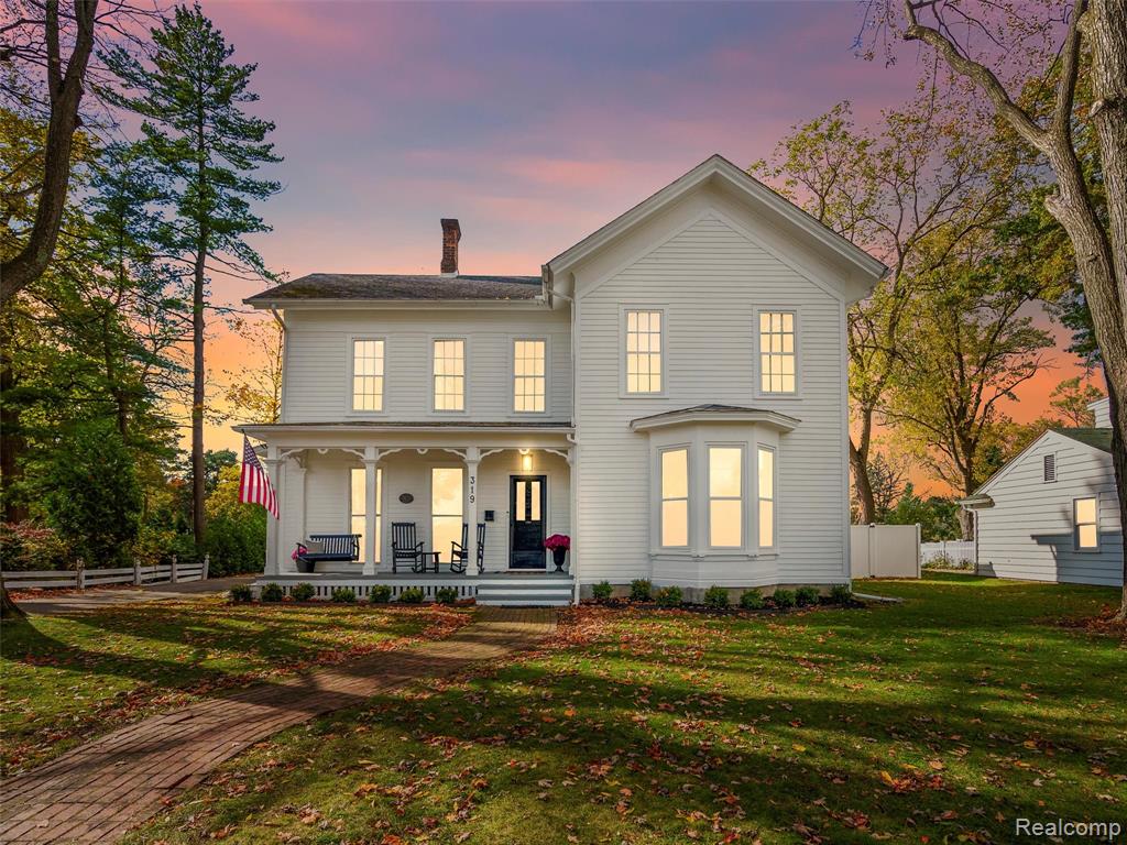 This Historic 1871 estate on OVER a half acre has been updated tastefully throughout, while maintaining all of the original charm and character that must be seen to appreciate!!  Updates of the home include CENTRAL AIR (space pak cooling), new siding, exterior and interior paint, new carpet, half bath remodel, newer/high-end appliances (Sub-Zero fridge/Wolf stove), updated lighting and fixtures.  The in-law suite has a remodeled kitchen, all new appliances, and a new sliding glass door leading to the back porch with sunset views.  Main house (3150 square ft) includes 4/5 bedrooms and 2.5 baths, and over 3100 sq. ft.  In-law suite boasts over 1200 sq. ft. and 2br/1ba with newer furnace and central air as well.  All in all, 6 bedrooms, 3.5 baths, and 4400 sq. ft. of total living space!  Large backyard area with new privacy fence immediately behind home,  PLUS huge backyard beyond with firepit.  This beauty is located in right in the quaint village of Romeo and is within walking distance to all of the local shops, restaurants, and schools!!