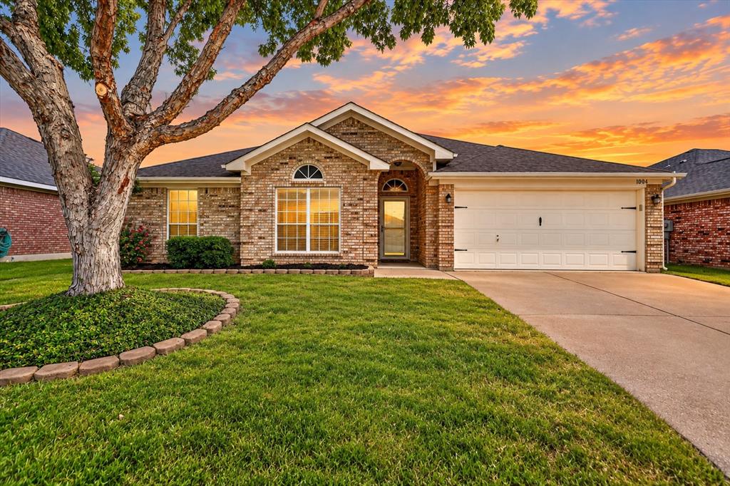 Welcome to this beautiful 4-bedroom, 2-bath home in sought-after Alsbury Estates that truly shows pride of ownership! Offering an impressive combination of space, comfort, and versatility, this home is ready to impress.Step inside to a spacious open-concept living area featuring engineered wood floors, crown molding, built-ins, and a cozy wood-burning fireplace. The oversized island kitchen is the heart of the home, featuring a large breakfast bar, durable solid-surface countertops, tile backsplash, pantry, built-in microwave, 20-inch tile flooring, and plenty of workspace. The adjoining spacious dining area is perfect for everyday meals or entertaining family and friends.The flexible floor plan offers three additional bedrooms, all with walk-in closets, including one with French doors that makes an ideal home office. A sunroom provides even more living space and possibilities.The spacious Owners suite features wood flooring, dual sinks, walk-in closets, and two linen closets. Storage is abundant throughout, including built-in cabinetry in the separate utility room and an extended 2-car garage with additional storage space.Step outside to a private backyard designed for relaxing and entertaining, complete with an impressive 22x20 extended patio, a 10x8 storage building, and sprinkler system. With generous room sizes, exceptional storage, flexible living spaces, and a backyard made to enjoy, this well-cared-for Alsbury Estates home shows pride of ownership throughout and is one you’ll want to see in person!