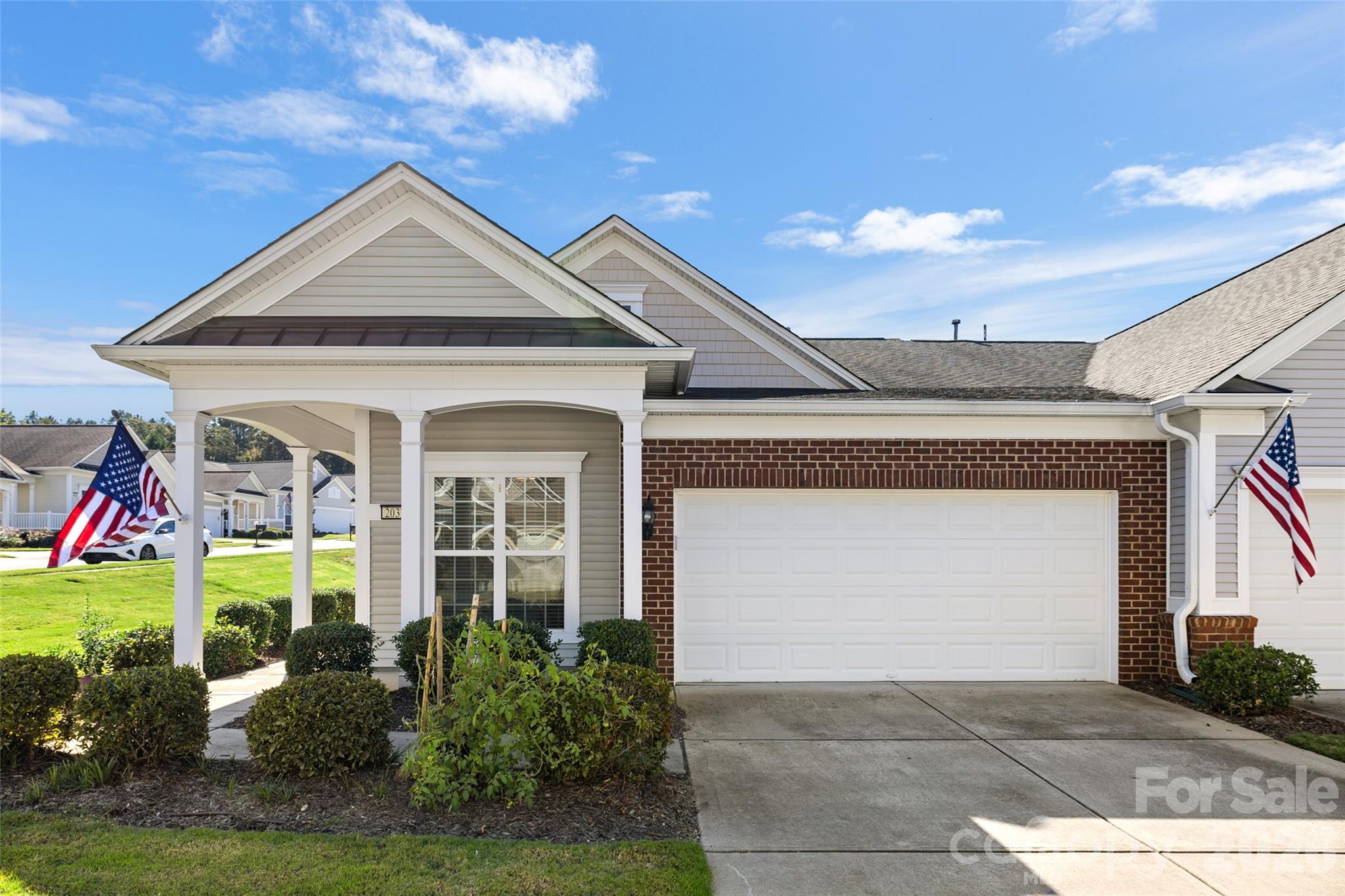 Enjoy indoor and outdoor living in this charming end-unit home offering 2 bedrooms and 2 baths. A covered front entry welcomes you into a bright interior with wood flooring throughout the main living areas, crown molding and decorative wainscoting. Large windows fill the living room with natural light, while the adjoining dining area provides a welcoming space to gather. The kitchen features granite countertops, warm wood cabinetry, a tile backsplash and stainless steel appliances, including a double-oven electric range. Just off the dining area, the screened porch extends your living space outdoors, offering a comfortable spot for morning coffee or relaxing with friends. The primary bedroom’s walk-in closet features an impressive built-in organization system with drawers, shelving and multiple hanging areas to keep everything neatly arranged. A second bedroom and full bath provide room for guests, while the office offers flexibility for work or hobbies. A separate laundry room with overhead shelving adds everyday convenience, and an attached two-car garage completes the home. Enjoy Sun City Carolina Lakes’ resort-style amenities, including indoor and outdoor pools, fitness centers, tennis and pickleball courts, walking trails and a variety of clubs and activities! HOA is in process of repairing the backyard as a part of the Villa Tree Mitigation Project