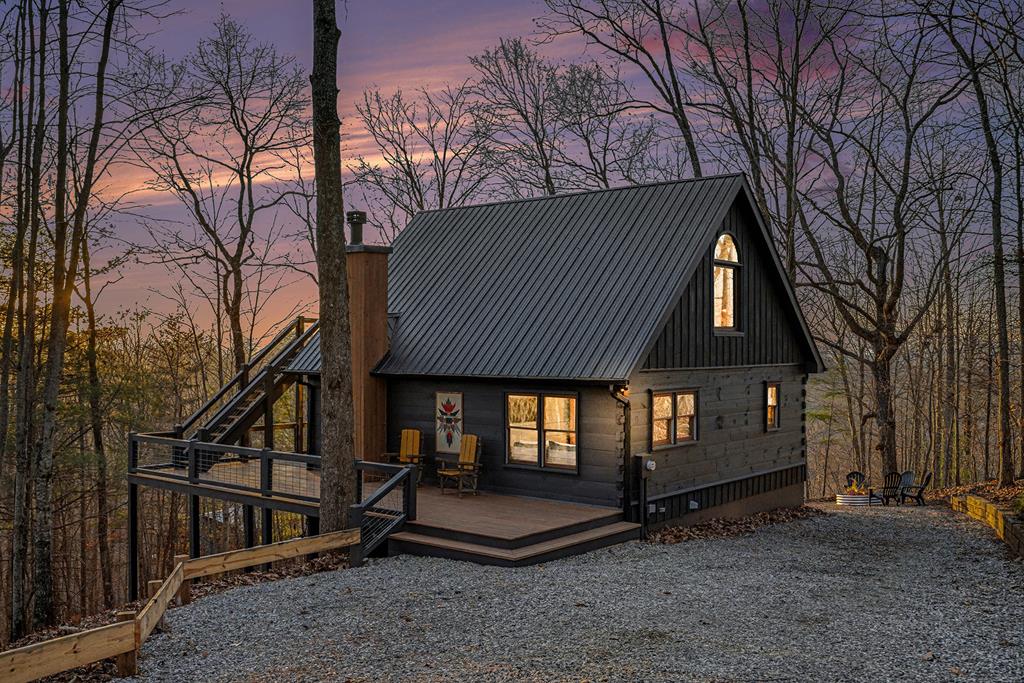 Welcome to your own slice of mountain heaven where every morning brings a gorgeous sunrise and every evening serves up stunning sunsets right outside your door. This completely renovated three-bedroom, three-bathroom log cabin sits pretty with amazing views that go on for miles across these beautiful mountains and valleys. Natural light pours through the windows all day long, warming up the cozy timber rooms and making you feel right at home. This cabin has three levels of comfortable living space, and every single one shows off those incredible mountain views through big windows that let you watch nature do its thing. The finished basement is perfect for hanging out, with stone touches and a fun game room where you can gather while watching snow dust those faraway peaks. Up top, there's a fantastic observation deck that feels like your own private lookout point, perfect for watching the morning fog roll through the trees. Tucked away in these gorgeous Appalachian mountains, this cabin puts you close to Blue Ridge, Murphy, and McCaysville/Copperhill for all your shopping, dining, and brewery hopping needs. Whether you're hunting for local crafts, trying craft beer, or enjoying good home-style cooking, authentic mountain life is right here waiting.This mountain getaway is also a smart investment opportunity. With these breathtaking views, genuine rustic charm, and great location, guests will love escaping here from their busy lives. The thoughtful renovation keeps all that authentic mountain character while adding modern comforts that folks really appreciate.Each bedroom offers comfortable sleeping with those amazing mountain views, while three full bathrooms make it easy for bigger groups. The open layout makes sure you can enjoy those sweeping views from just about everywhere in this mountain retreat.This cabin is the perfect mix of peaceful getaway and solid investment.