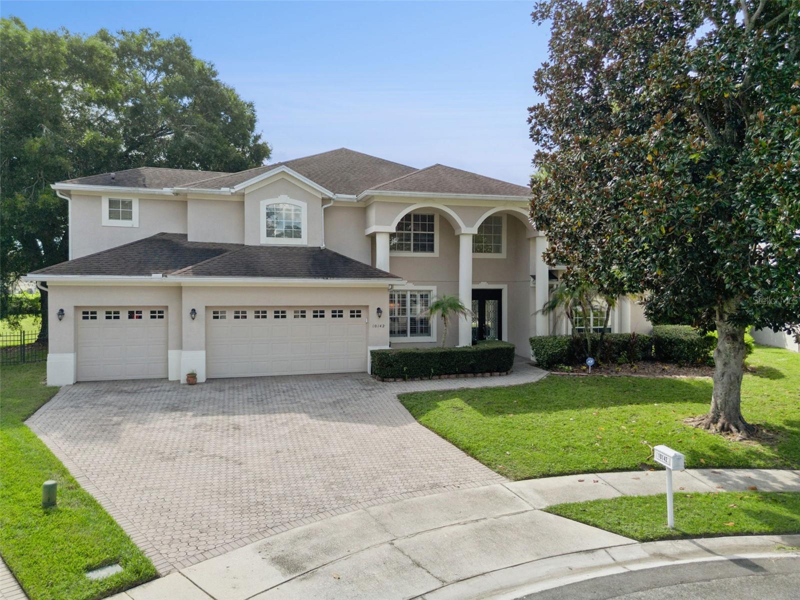SPACE TO SPREAD OUT, ROOM TO ENTERTAIN, AND A LOCATION THAT PUTS ORLANDO'S BEST AT YOUR DOORSTEP! Tucked away at the end of a quiet cul-de-sac in the desirable Emerald Forest community of Dr. Phillips, this spacious 5-bedroom, 4.5-bath pool home offers over 3,500 square feet of living space on an oversized .37-acre lot. The expansive, open floor plan features generous formal living and dining rooms, a large family room, and a spacious kitchen with updated countertops, appliances, fixtures, and freshly painted cabinetry. One of the home's standout features is its TWO PRIMARY SUITES, including a spacious downstairs retreat and a second full en-suite upstairs—an ideal arrangement for multigenerational living, extended guests, or anyone seeking additional privacy and flexibility. Bathrooms have also been tastefully refreshed with updated vanities, countertops, and fixtures. Step outside and you'll discover another of this property's greatest assets: an expansive screened pool deck overlooking a remarkably generous backyard with no immediate rear neighbors and a glimpse of the neighboring pond from the rear corner of the property. Whether entertaining friends, relaxing poolside, or enjoying the extra room to roam, the outdoor space offers possibilities that are increasingly difficult to find. A three-car garage provides abundant space for vehicles, storage, and recreational gear. And while the setting feels comfortably removed from the bustle, you're just minutes from Disney, Restaurant Row, shopping, dining, and Orlando's major attractions. With its generous proportions, versatile floor plan, exceptional outdoor living space, and convenient location, this home delivers an appealing combination of features in one of Southwest Orlando's most sought-after communities.