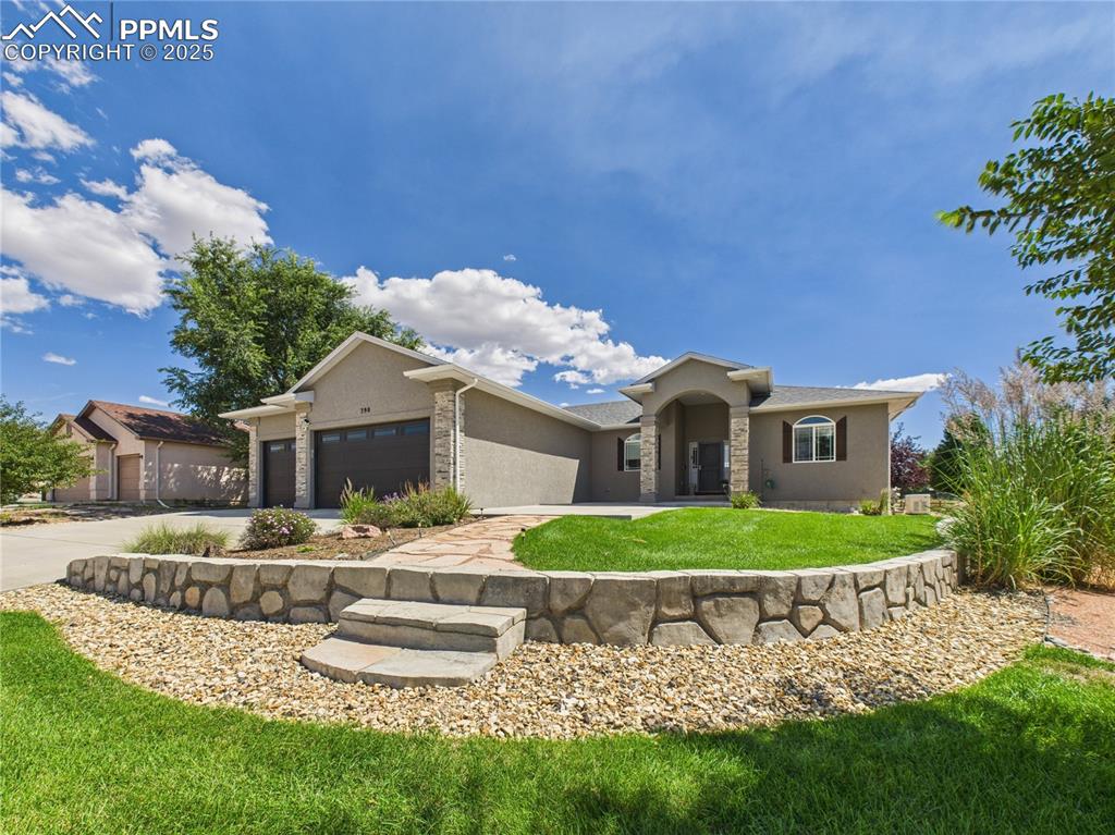 Welcome to this stunning ranch-style home overlooking the golf course! Offering 3,721 sq. ft. of beautifully designed living space, this residence boasts 5 bedrooms and 4 bathrooms. The first floor features an open-concept layout with soaring vaulted ceilings, luxurious LVT flooring, a cozy fireplace, and an inviting kitchen. This chef's dream kitchen is equipped with granite countertops, a massive island, and a convenient walk-in pantry. The Primary Bedroom offers direct access to the beautiful backyard, a spacious walk-in closet, and an ensuite 5-piece bathroom complete with a tile-inlaid standing shower and a lavish bath. Comfort extends throughout the home with 4 additional spacious bedrooms and 3 more luxury bathrooms. The basement provides a large family room, a convenient kitchenette area, and ample storage. Further enhancing this home is a 3-car attached garage, offering generous space for vehicles and all your storage needs. Exterior highlights include a charming front covered porch area, meticulously maintained garden landscaping, direct golf course access, a rear patio, and much more! This home seamlessly blends efficient layout with impeccable design, creating a stylish and functional haven for modern living. Discover your dream home today!
