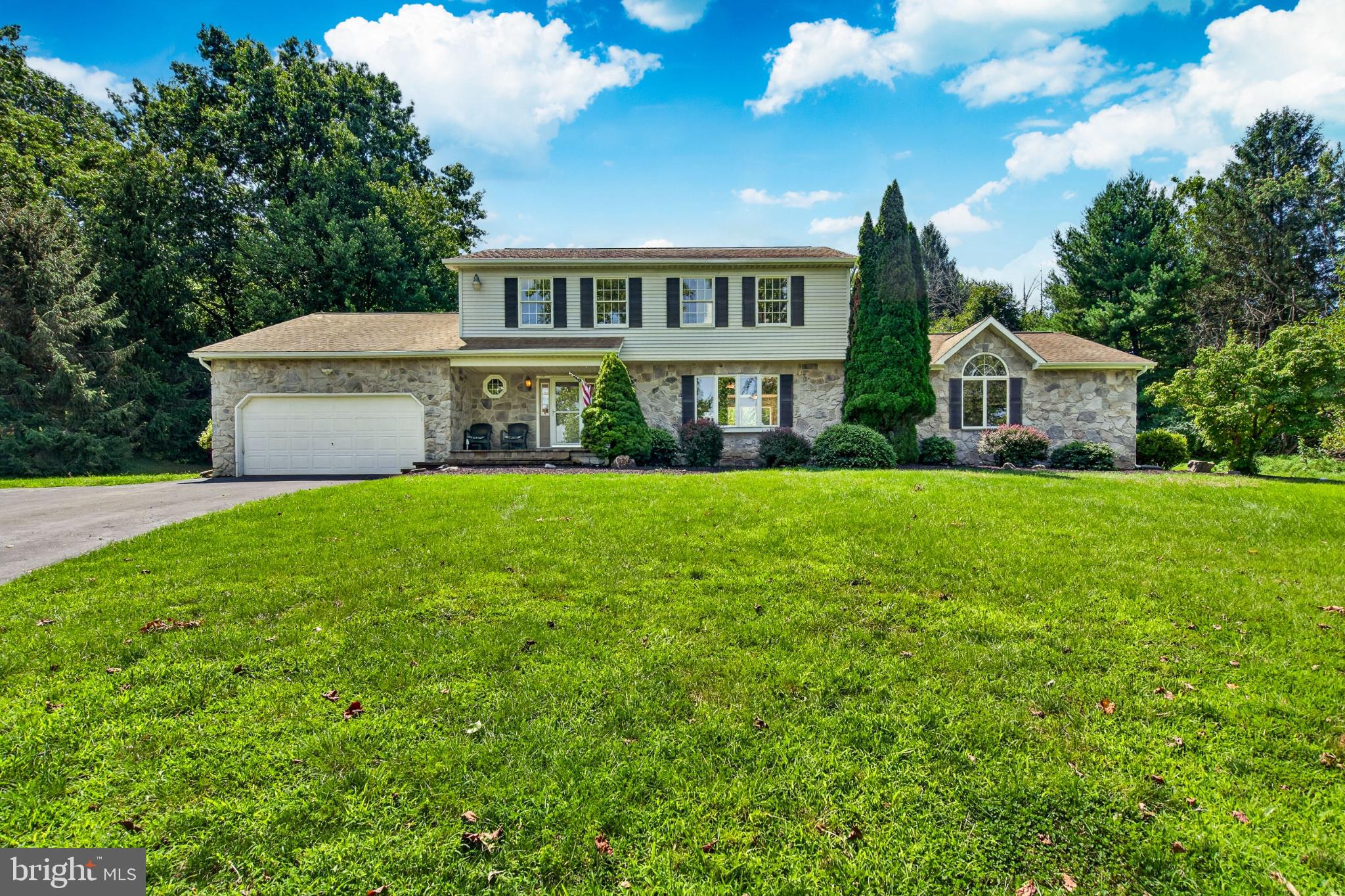 Nestled in a serene rural setting, this exquisite Colonial-style residence offers a harmonious blend of luxury and comfort, perfect for those seeking an exclusive lifestyle. Built in 1987 this detached home boasts a generous 3,078 square feet of finished living space, featuring five spacious bedrooms and five and a half bathrooms. As you approach the property, the charming exterior showcases a combination of durable vinyl siding and classic stone accents, creating a timeless appeal. The expansive 1.58-acre lot is beautifully landscaped, with additional lots that provide ample space for outdoor activities and gatherings. The property backs to lush trees, offering a tranquil backdrop and a sense of privacy that enhances the overall ambiance. Step outside to discover a delightful deck and inviting porch, perfect for enjoying morning coffee or evening sunsets. The outdoor space is further enhanced by a gazebo and a shed, providing both functionality and charm. For relaxation, unwind in the luxurious hot tub, surrounded by nature's beauty, or take in the picturesque views of the garden, pasture, and wooded areas. Inside, the home is equipped with high-end appliances, including an ENERGY STAR refrigerator, a self-cleaning oven, and stainless steel finishes that elevate the culinary experience. The main floor laundry adds convenience to daily living, while the two cozy fireplaces create a warm and inviting atmosphere throughout the home. The fully finished basement, complete with an outside entrance and walkout stairs, offers additional living space that can be tailored to your needs-whether it be a home theater, gym, or guest suite. The property also features a private asphalt driveway leading to a built-in two-car garage, ensuring ample parking for residents and guests alike. This residence is not just a home; it's a lifestyle. With green energy-efficient features, including a PV solar array and water recycling systems, you can enjoy modern living while being mindful of the environment. The combination of luxury, comfort, and sustainability makes this property a rare find. Experience the tranquility of rural living while being just a short drive from urban conveniences. This home is a true sanctuary, offering a perfect blend of elegance and warmth, ready to welcome you into a life of comfort and style.The rear yard has a fenced in area closer to the house with fruit trees and grape vines ....